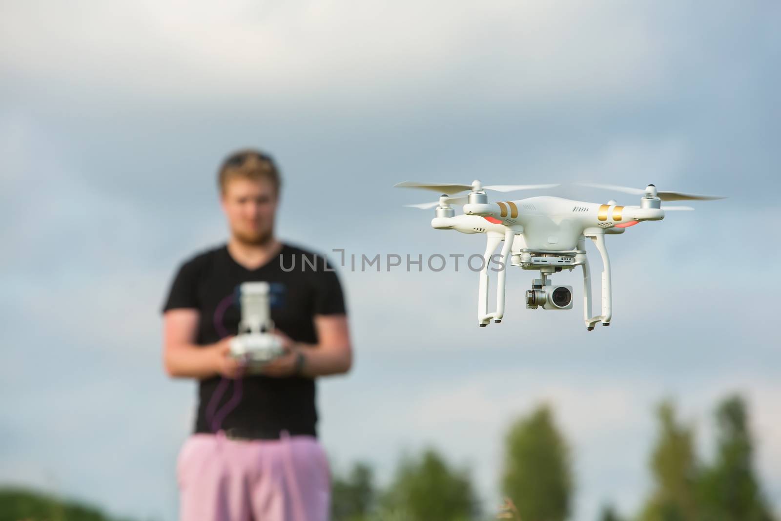 Single adult using remote control for a camera drone