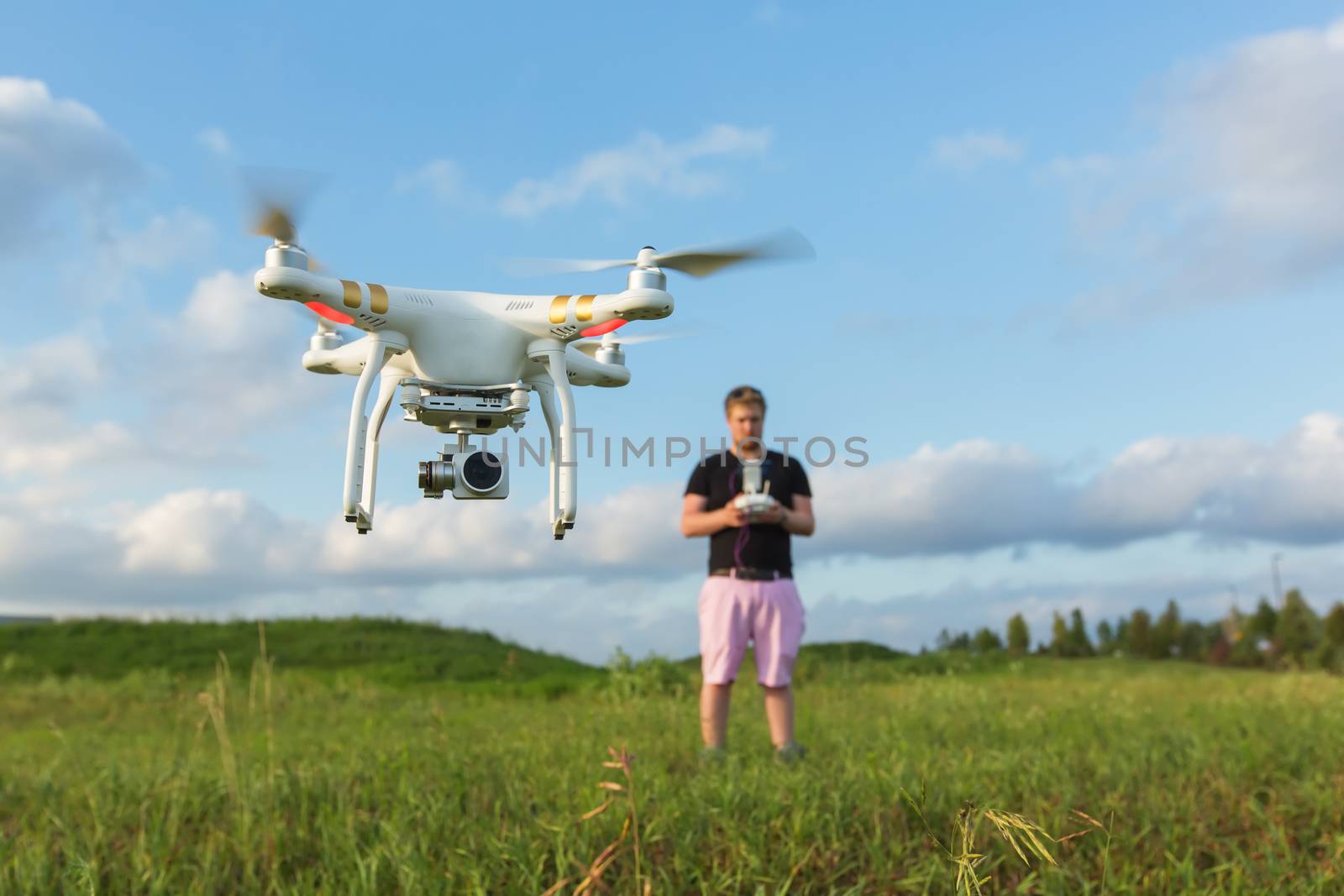 Person in field controlling drone with camera