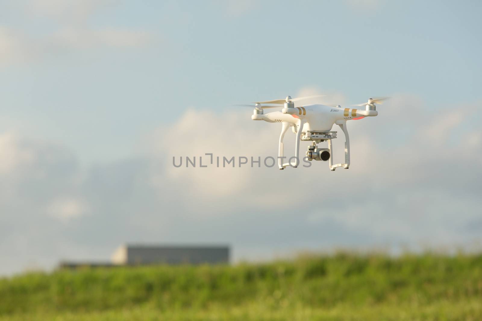 Camera drone quadrocoptor in mid air near building