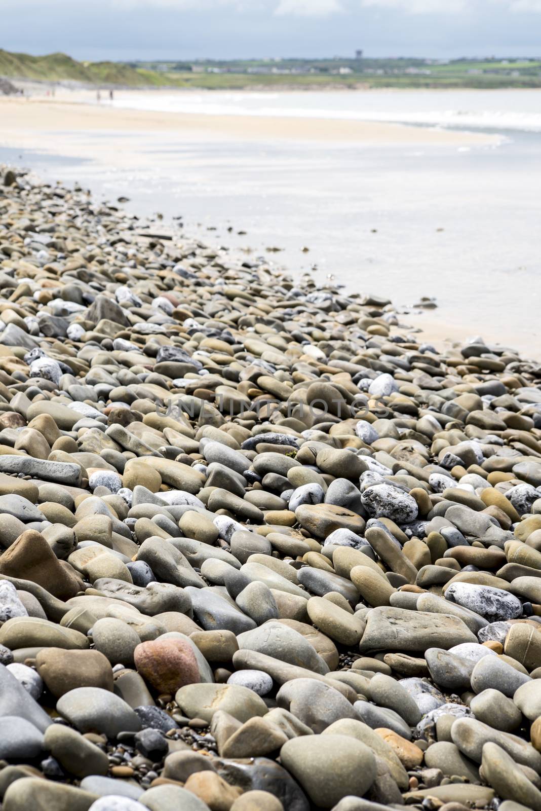 pebbled beach beside the links golf course by morrbyte