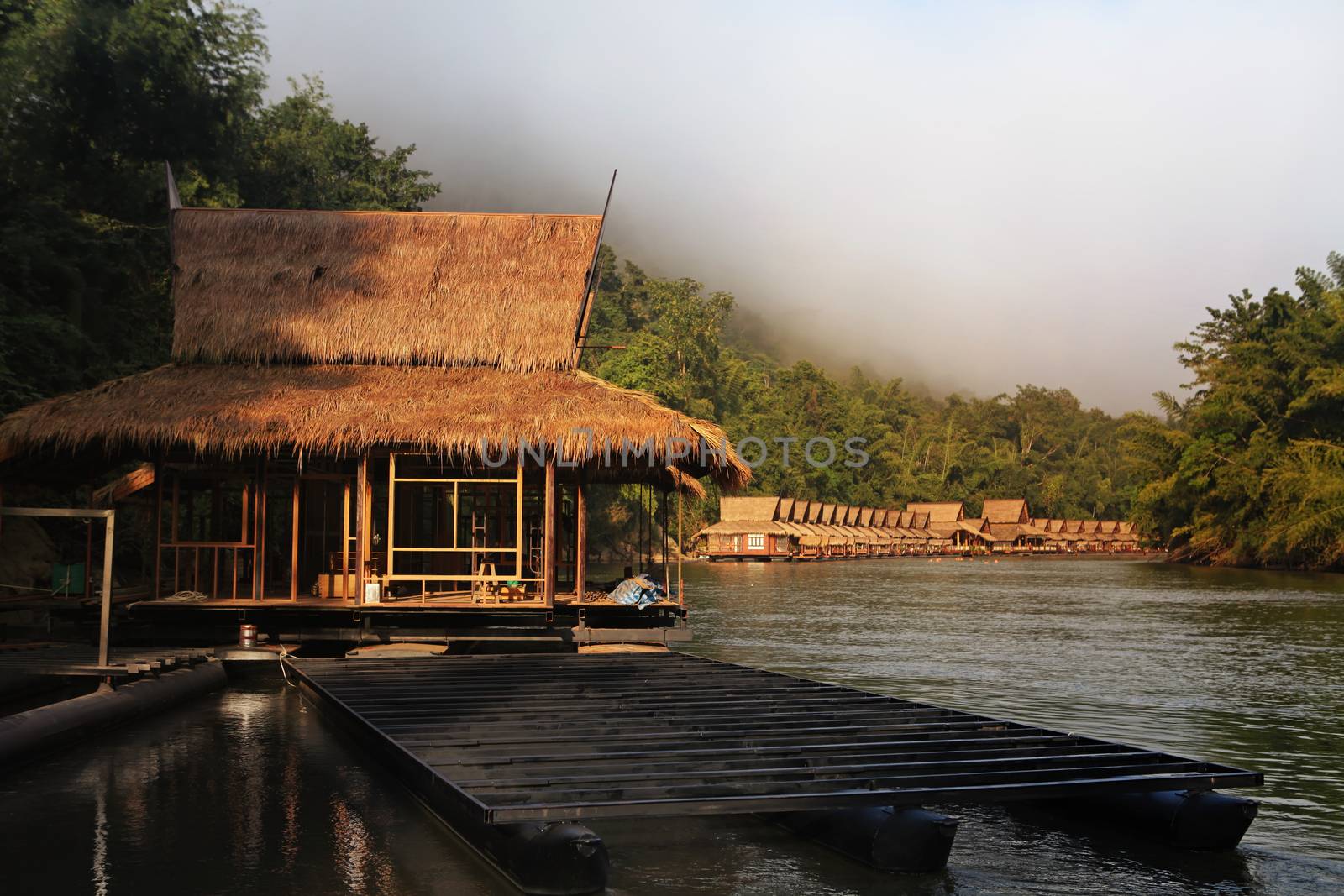 Hut near river and mountain in Thailand