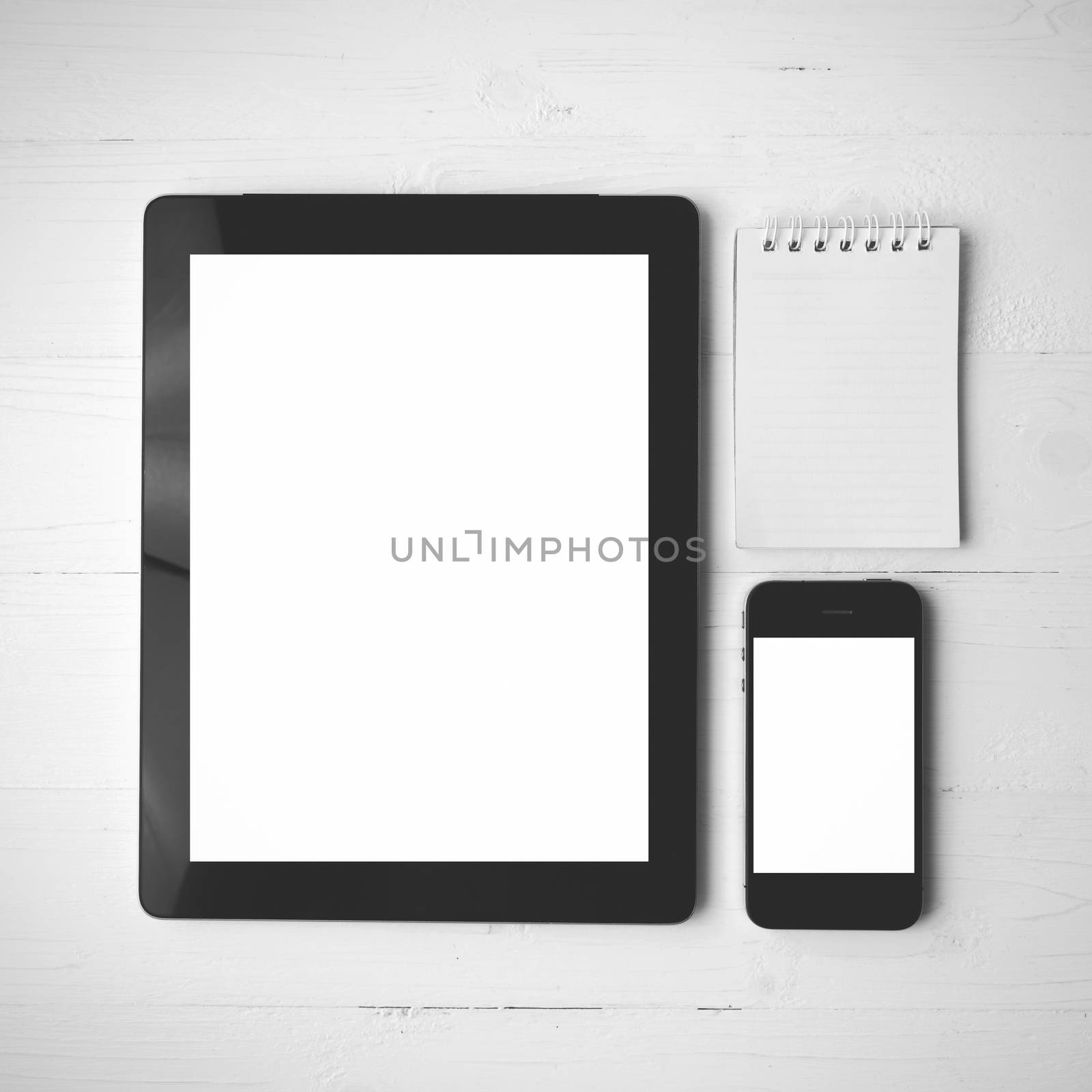 tablet and cellphone over white table black and white color style