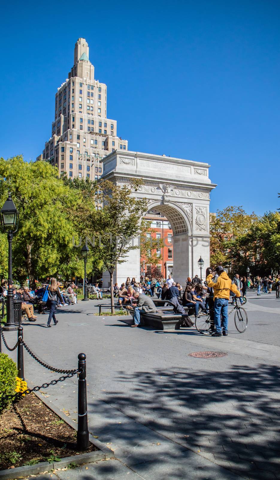 NEW YORK, USA, October 10, 2015: Unidentified people walking and resting in Washington Square Garden in Manhattan, New York.