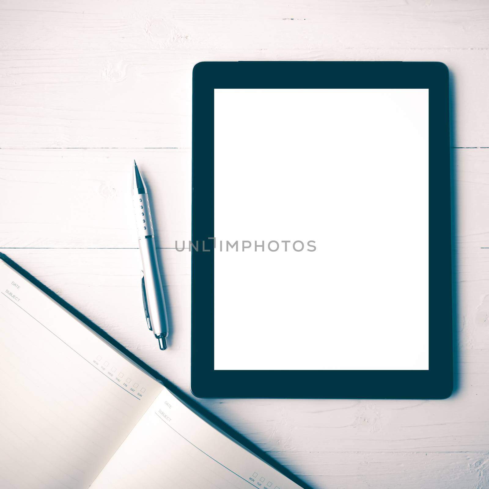 tablet with notebook and coffee cup over white table over white table vintage style