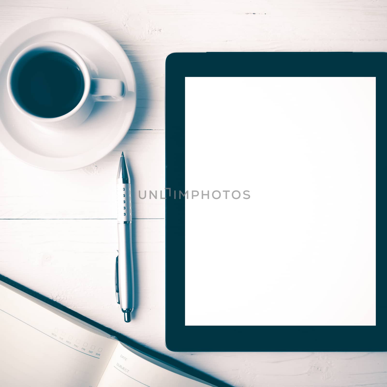 tablet with notebook and coffee cup over white table vintage style