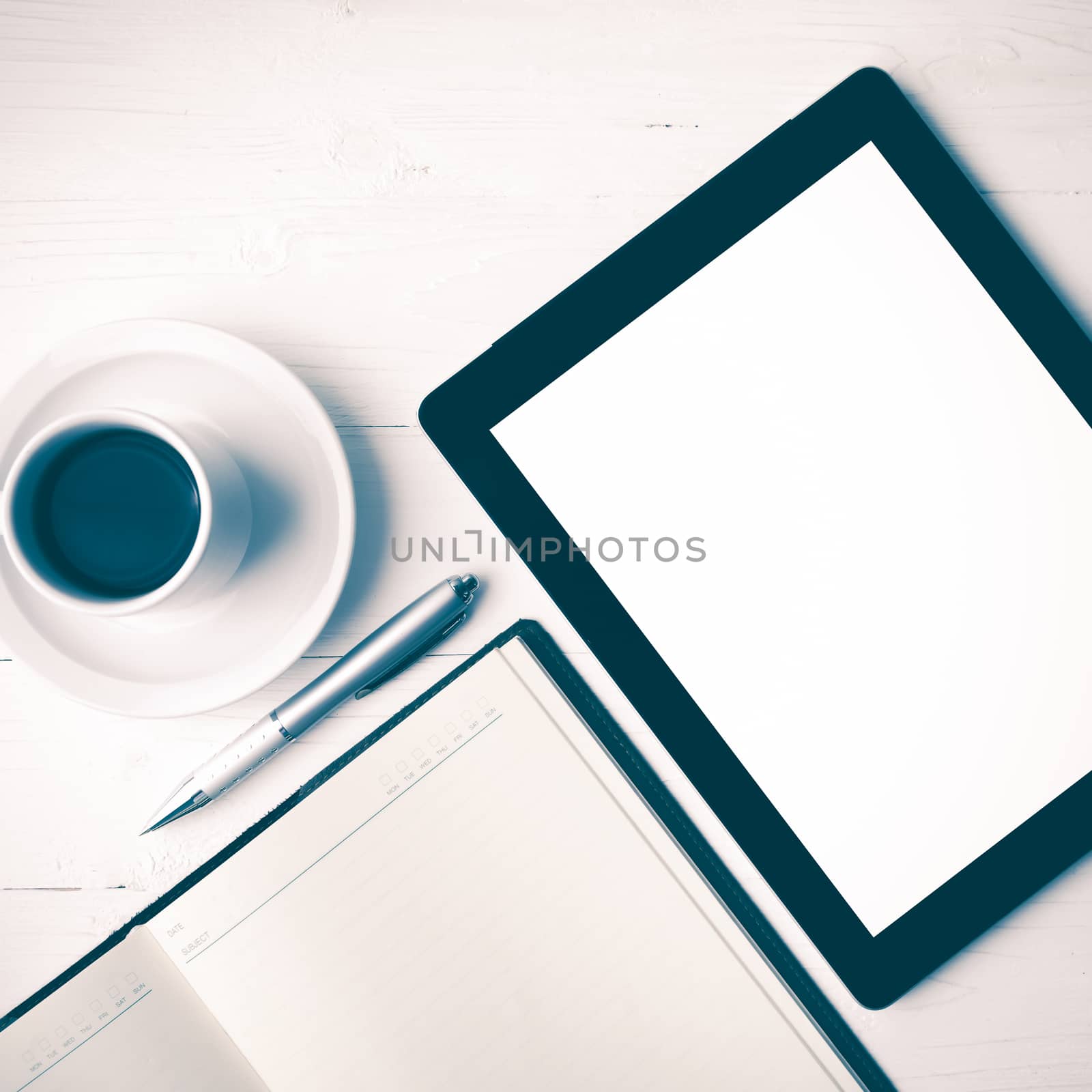 tablet with notebook and coffee cup over white table vintage style