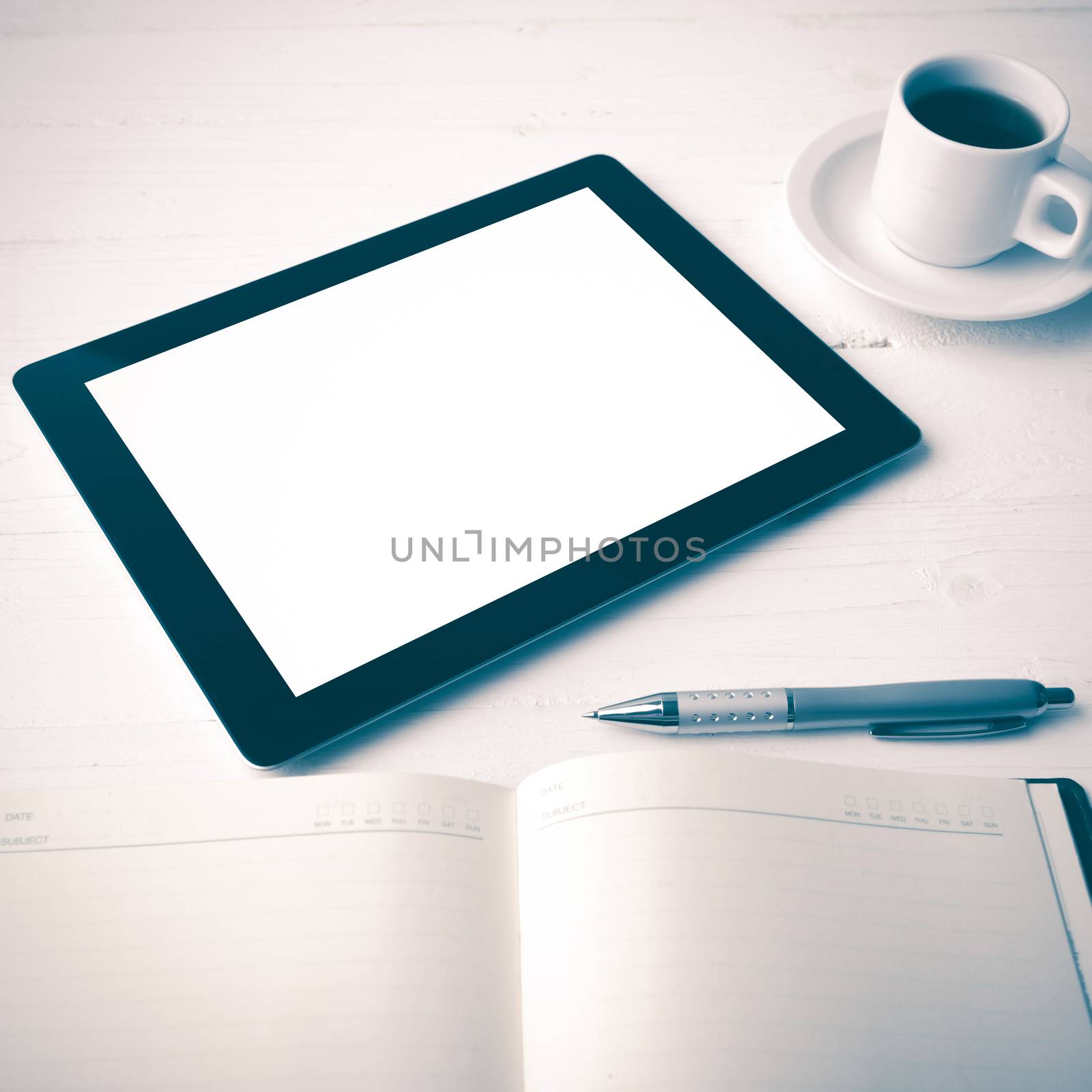tablet with office supplies over white table vintage style