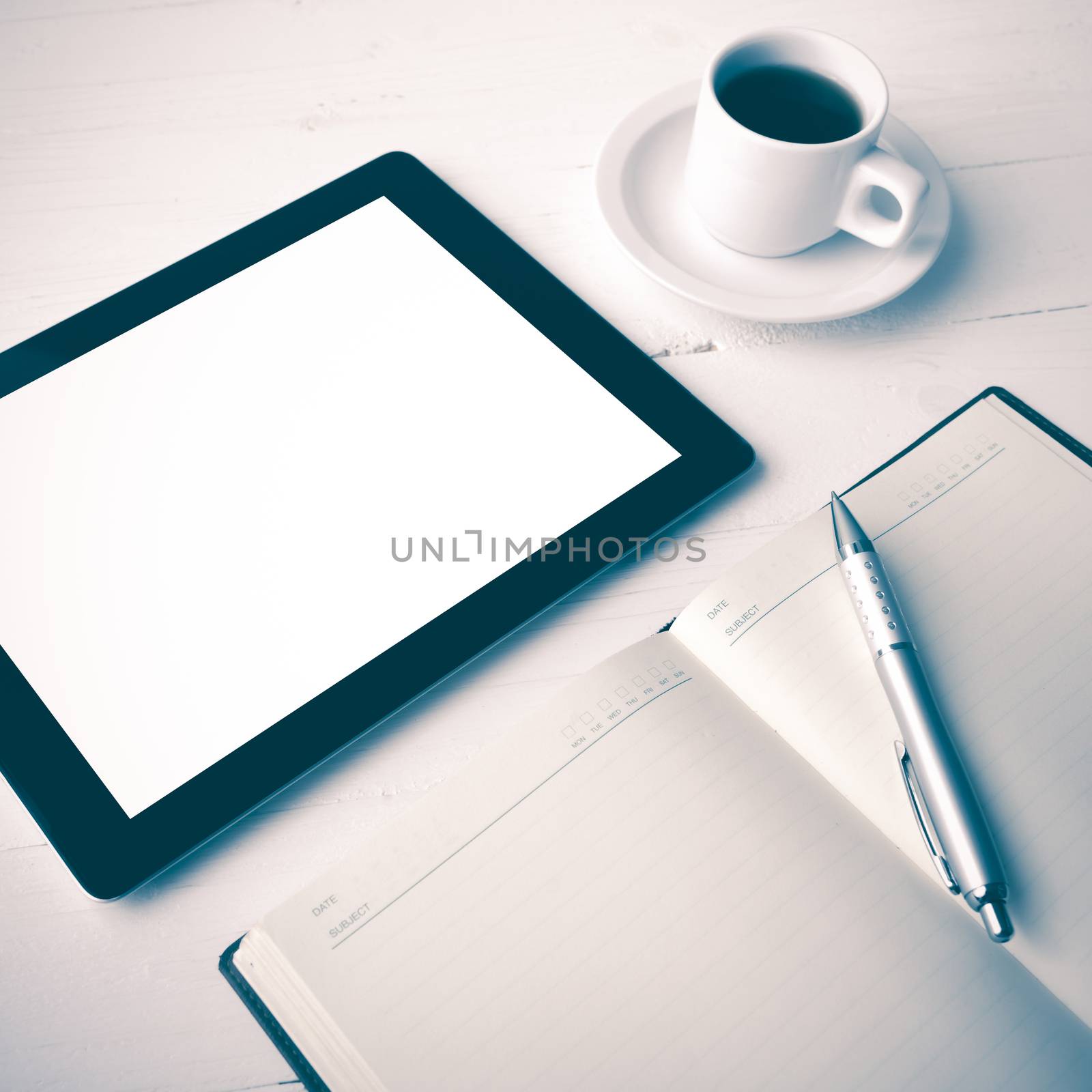 tablet with office supplies over white table vintage style