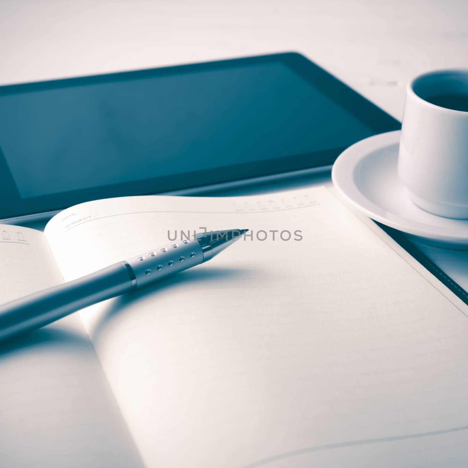tablet with office supplies over white table vintage style