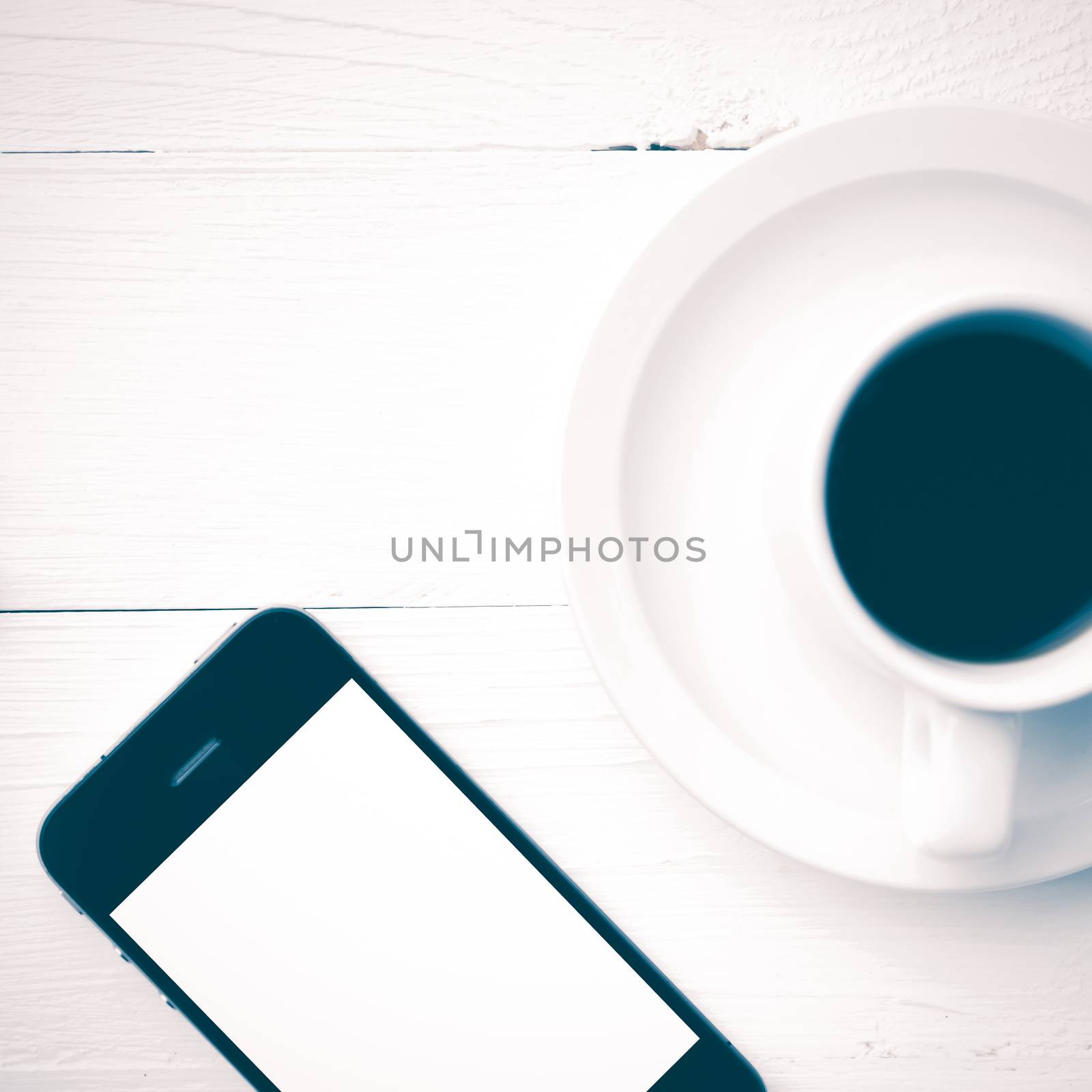 cellphone and coffee cup over white table vintage style