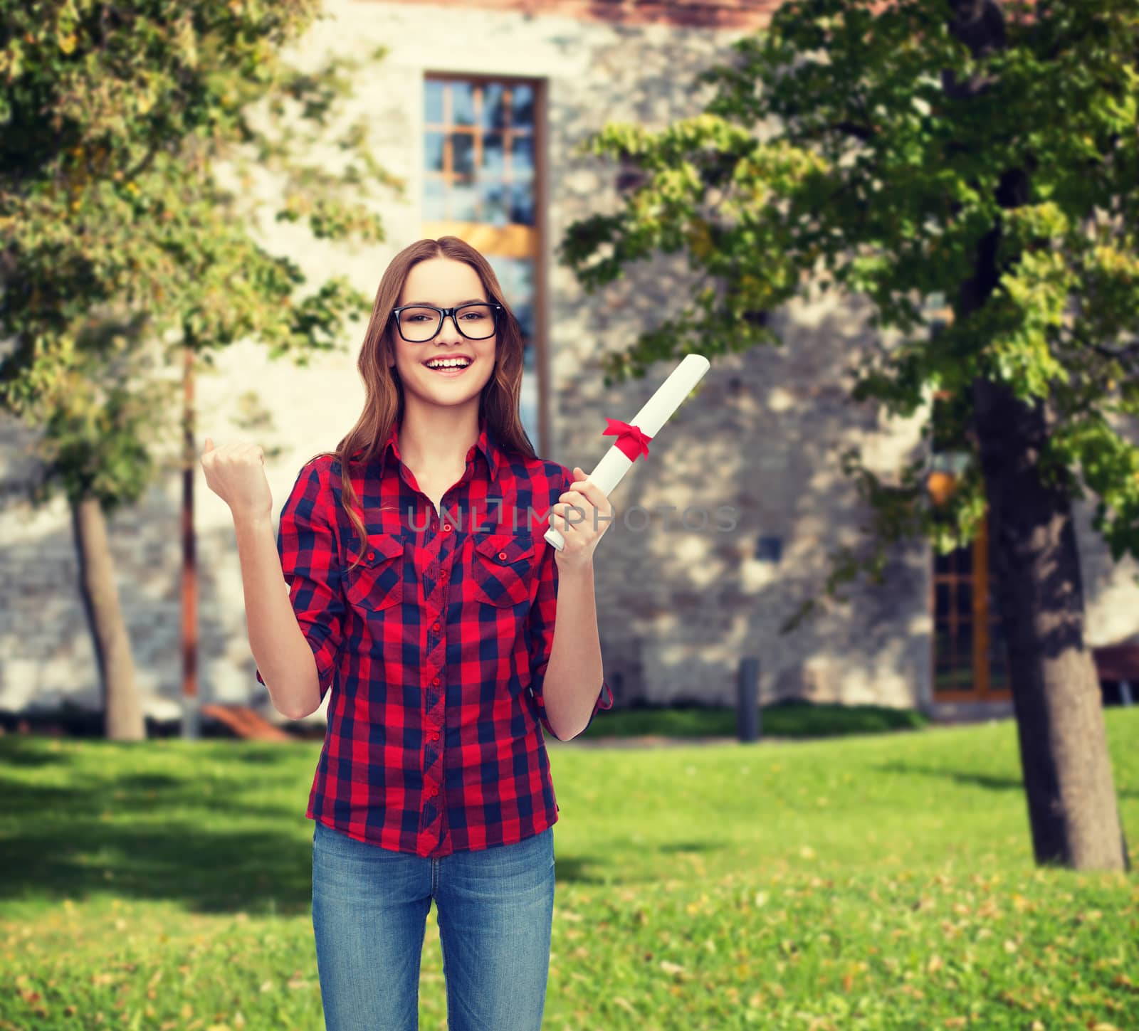 university and education concept - smiling female student in eyeglasses with diploma