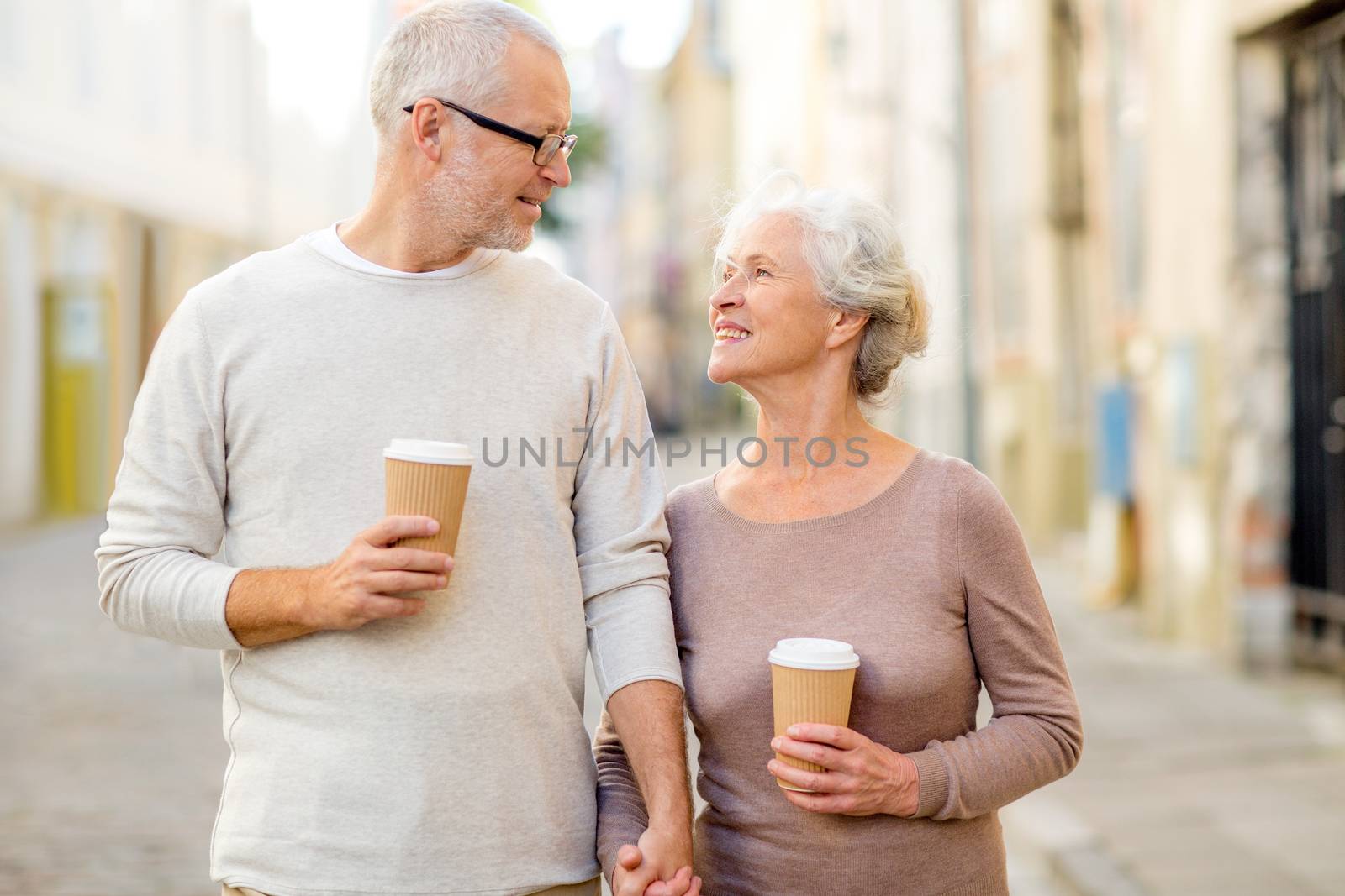 family, age, tourism, travel and people concept - senior couple on city street