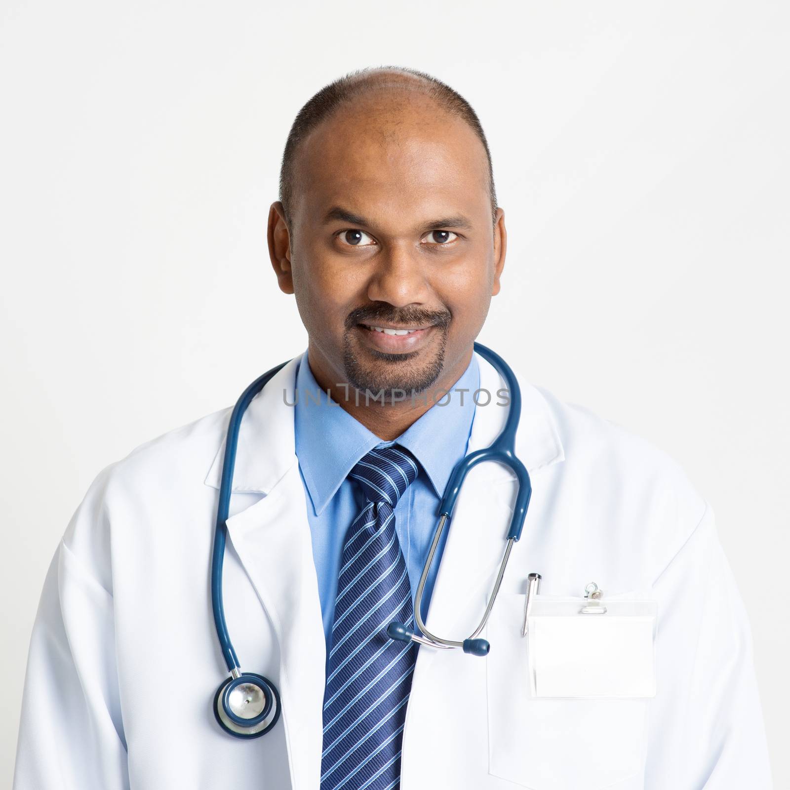 Mature Indian doctor smiling by szefei