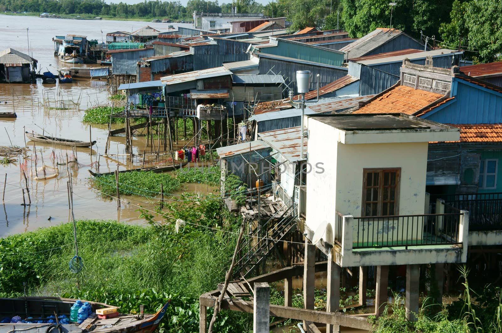 HONG NGU- VIET NAM- OCT 15: Residential on water, group of floating house of poor people on Mekong Delta river, precarious life, danger, home from sheet metal, Hongngu, Vietnam, Oct 15, 2015