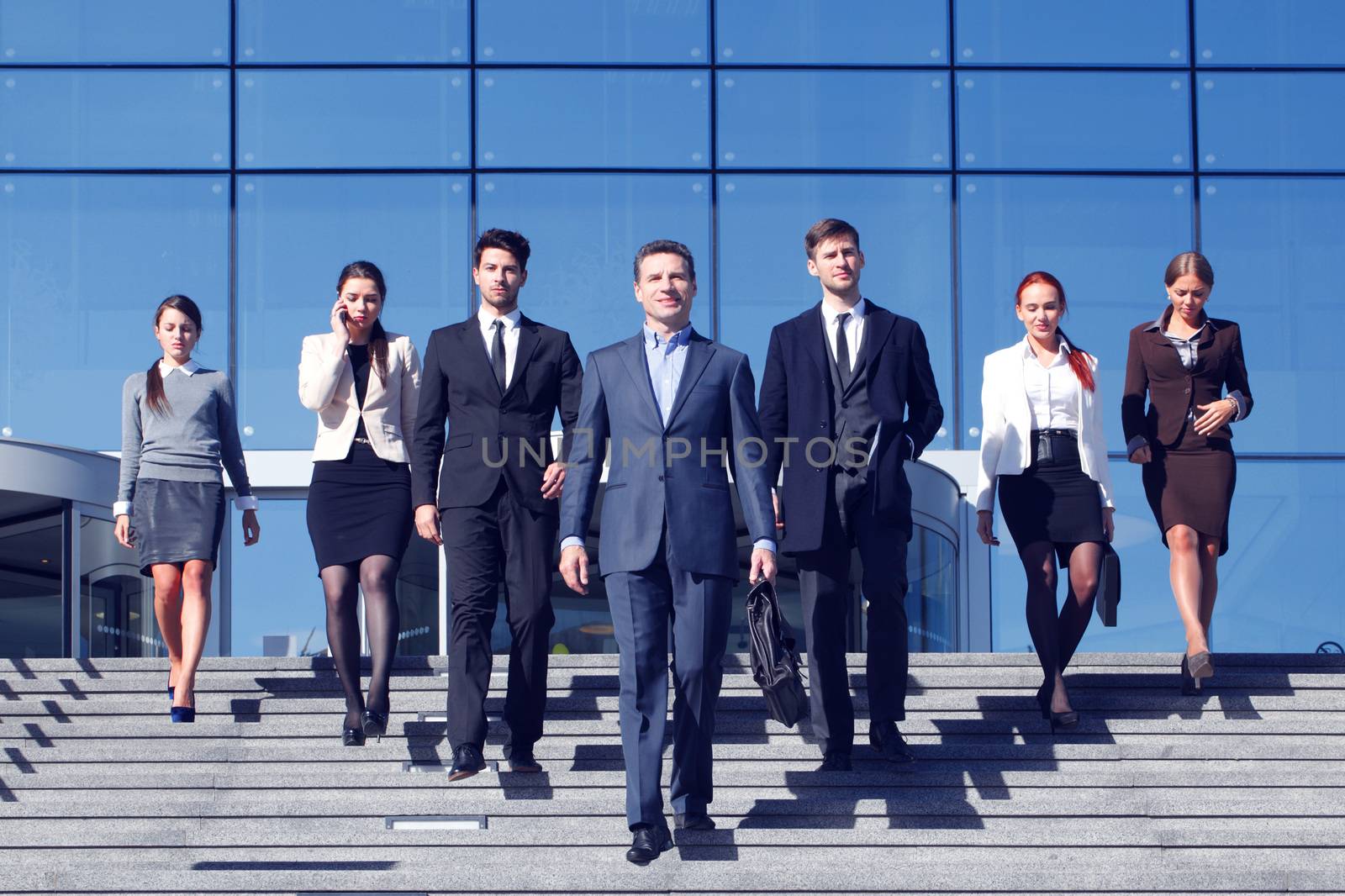 Team of diverse business people at stairs of company office building
