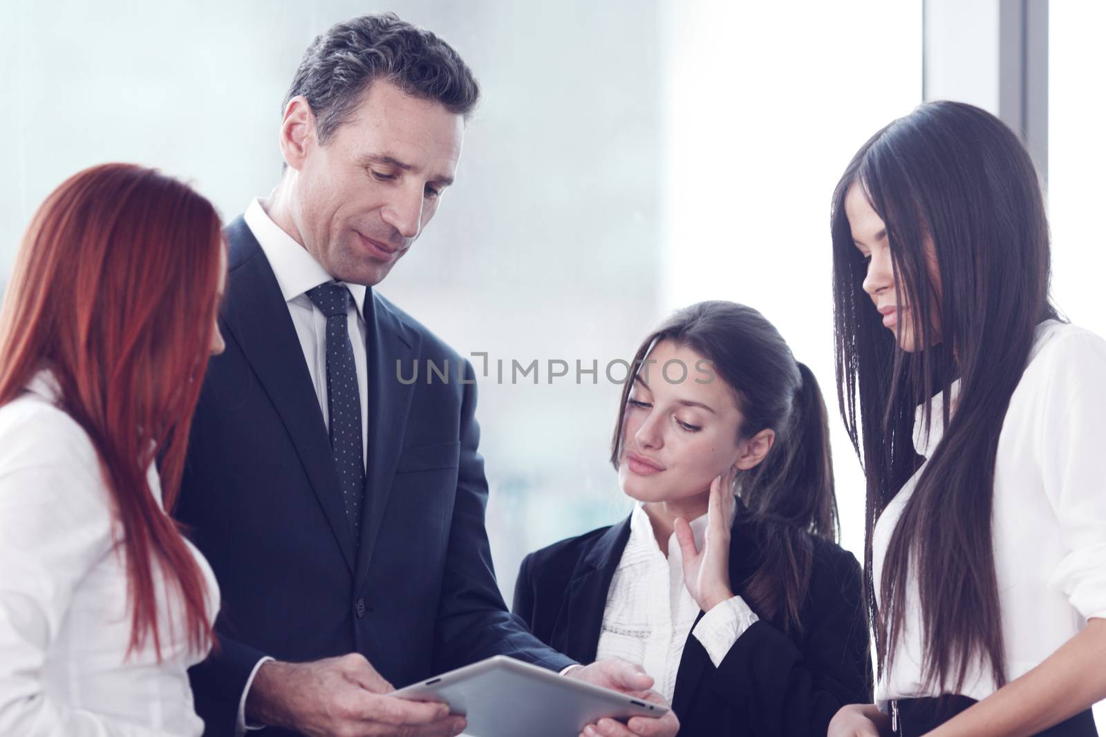 Group of business people using tablet in office