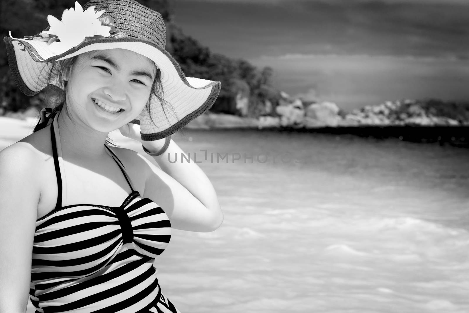 Black and white photograph for background, tourist girl in swimsuit standing with happiness on the beach and sea at Koh Miang Island, Mu Ko Similan National Park, Phang Nga province, Thailand