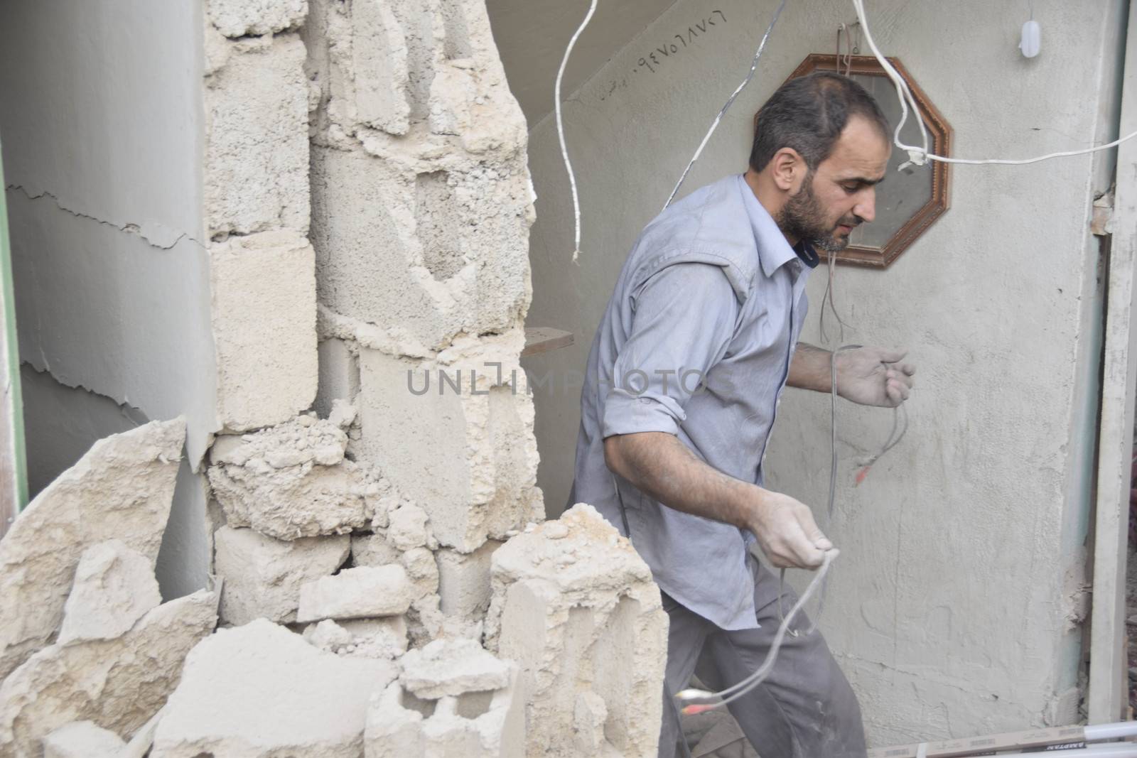 SYRIA, Harasta: This picture shows a man walking through the rubble in the the Syrian town of Harasta on October 23, 2015 following a series of recent airstrikes. The Syrian army launched an offensive in the area which targeted various rebel opposition. In addition to airstrikes, the Syrian army also launched a ground operation in the region.