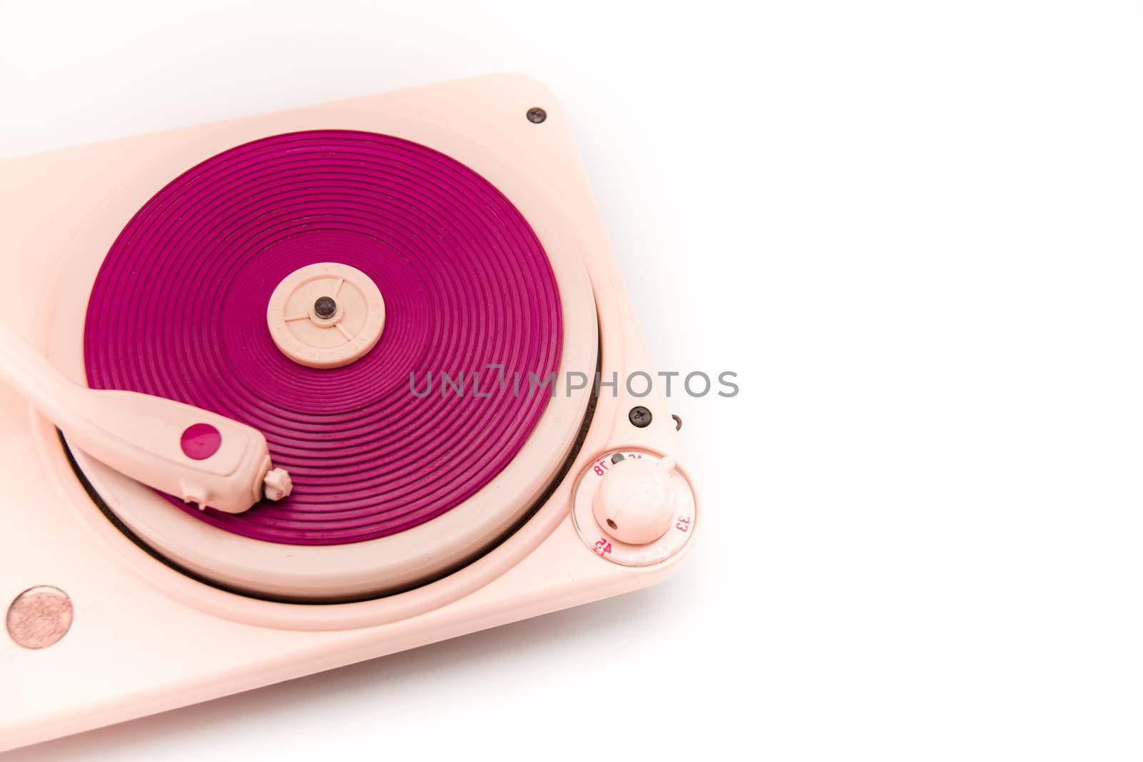 Vintage pink record player on white background with copy space on the right.