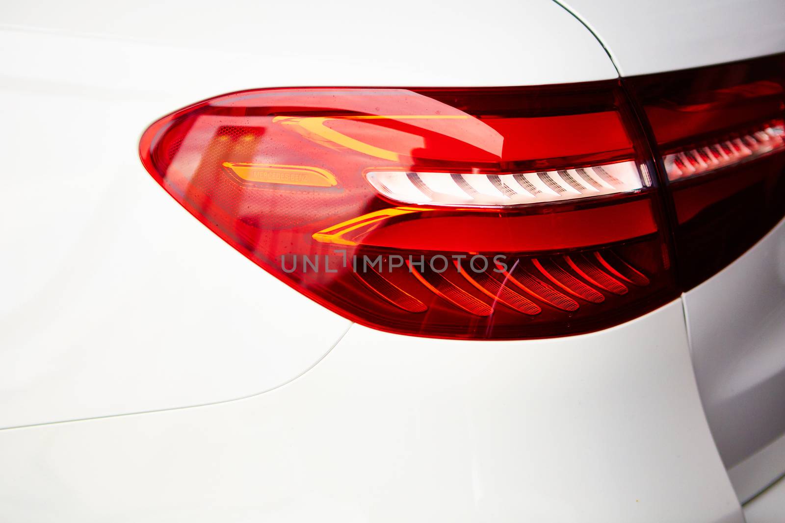 Detail on the rear light of a white car