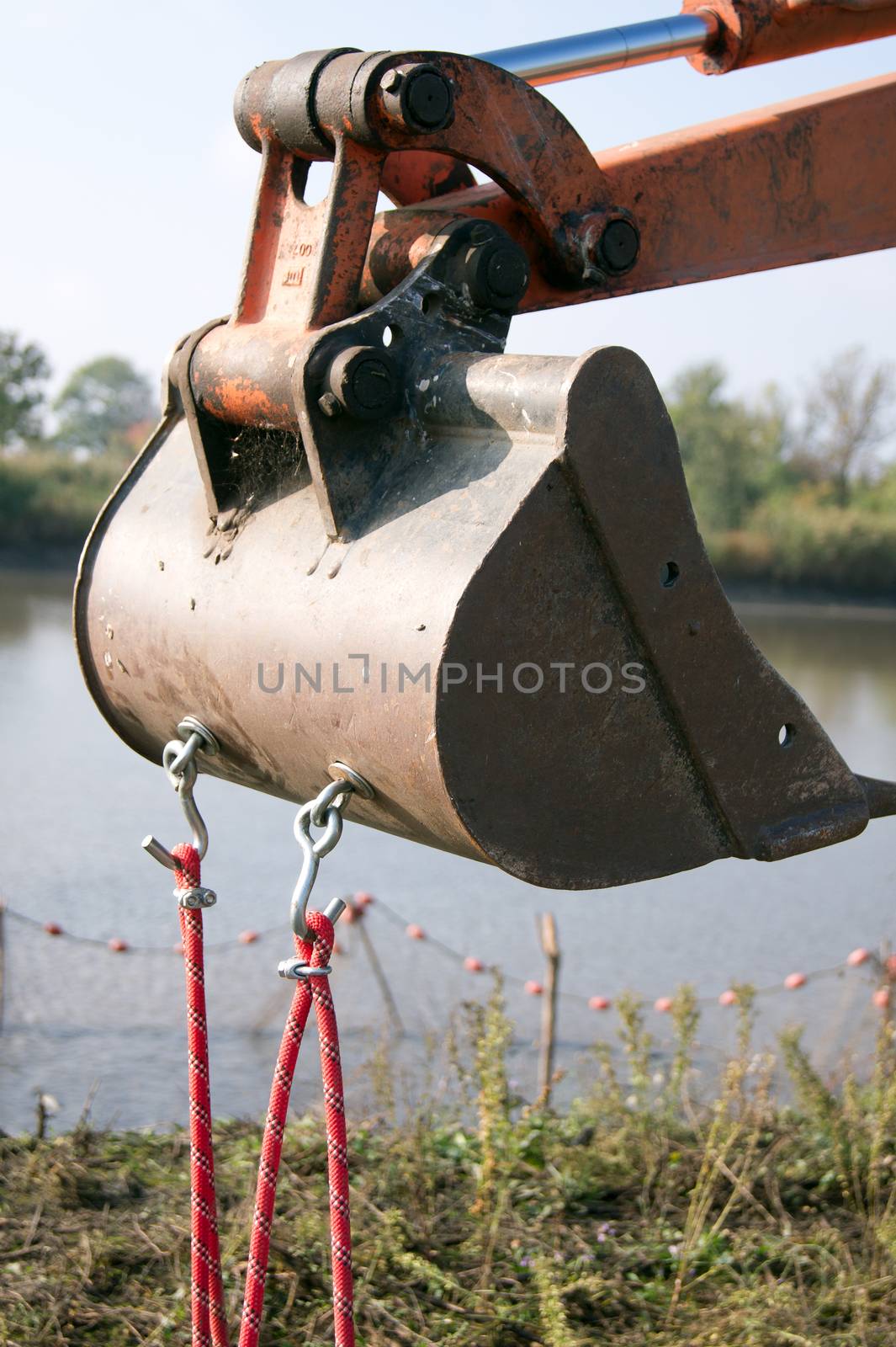 The crawler excavator operator stopped by the lake.