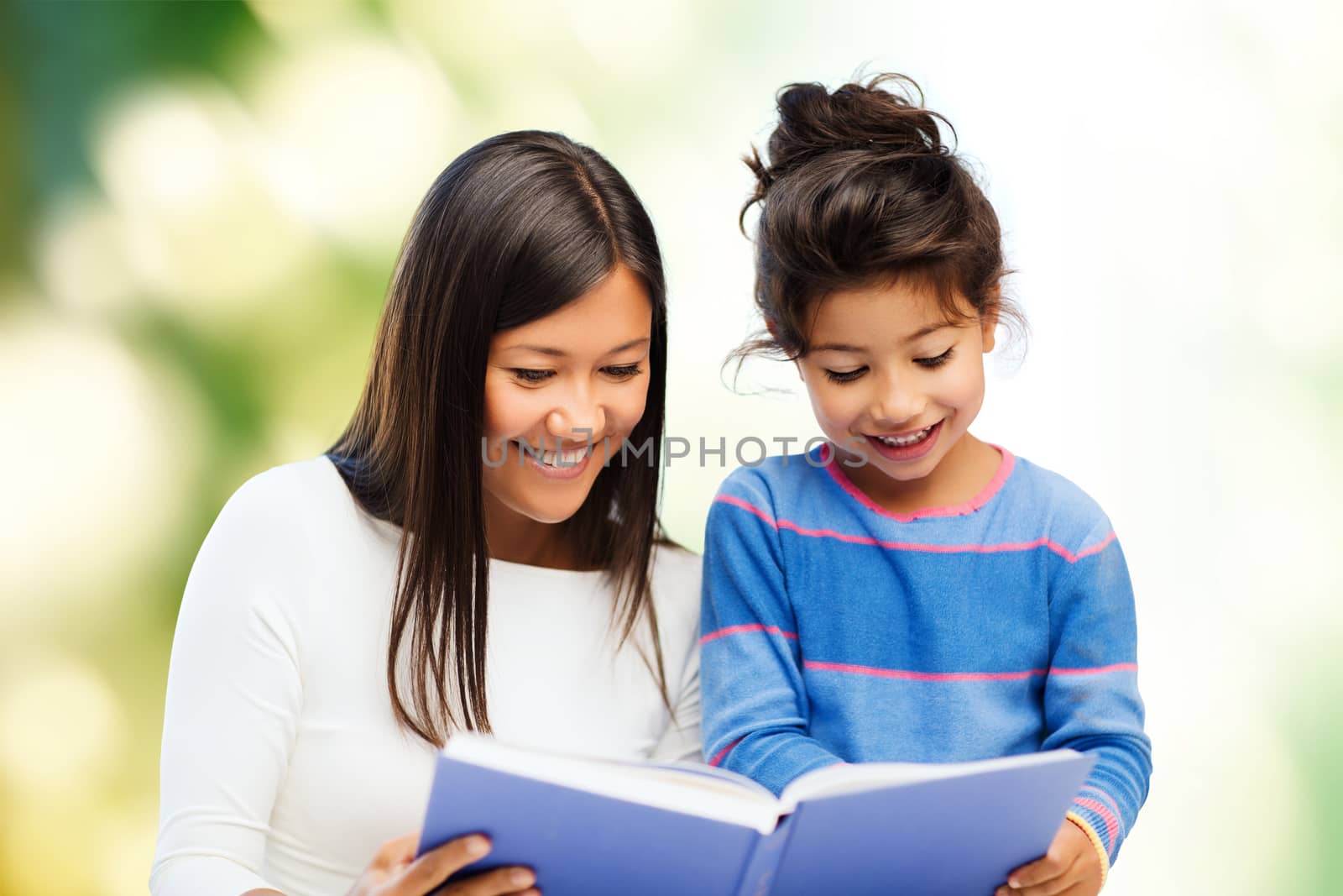 happy mother and little daughter reading book by dolgachov