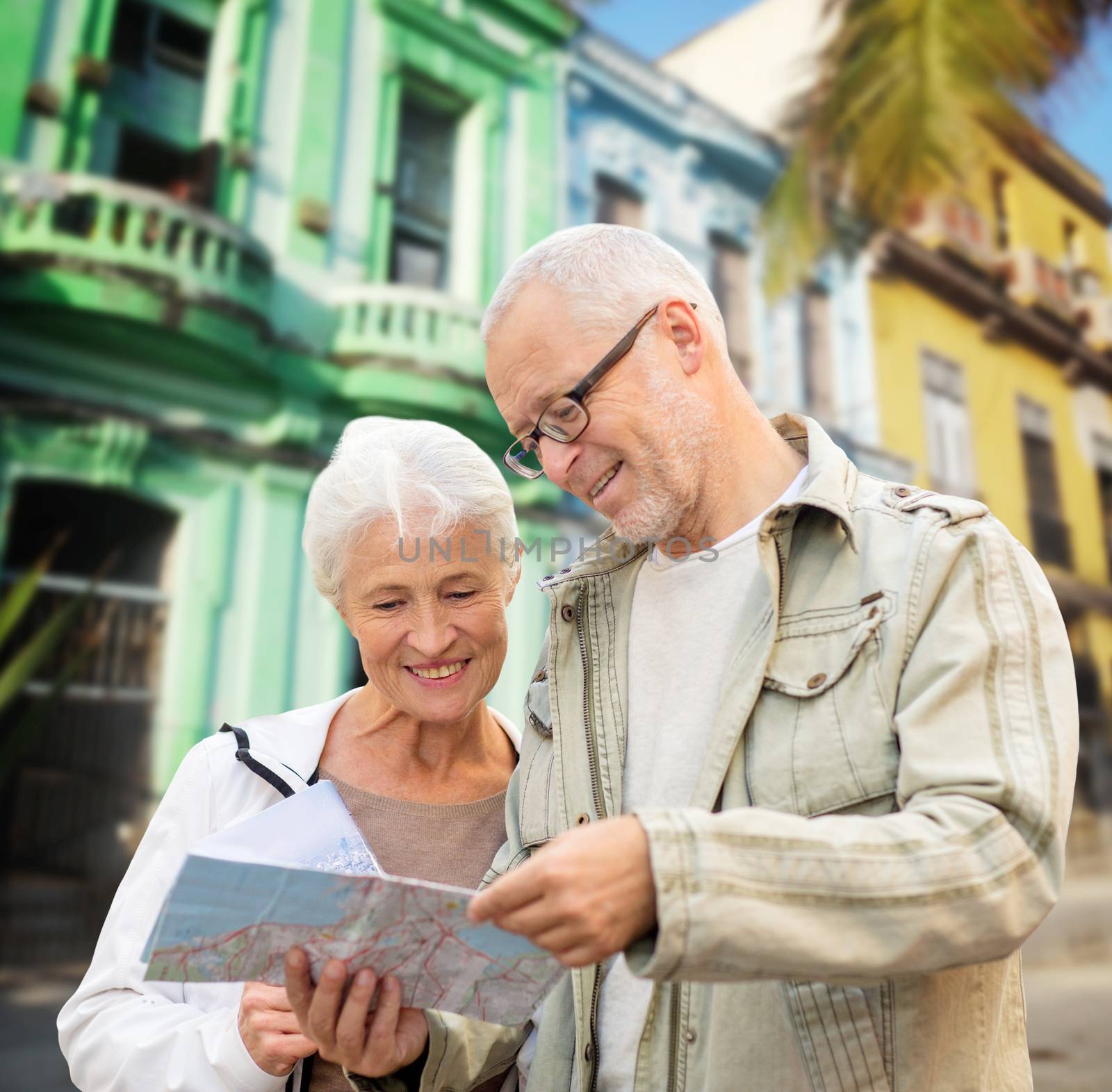 family, age, tourism, travel and people concept - senior couple with map over latin american city street background