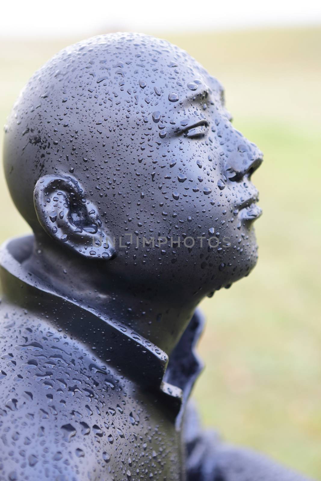 BONDI, AUSTRALIA - OCTOBER 22, 2015;  Annual Sculpture by the Sea free public event.  Exhibit titled Man on Ball - a collection of painted bronze statues on squatting on balls each with expressive features