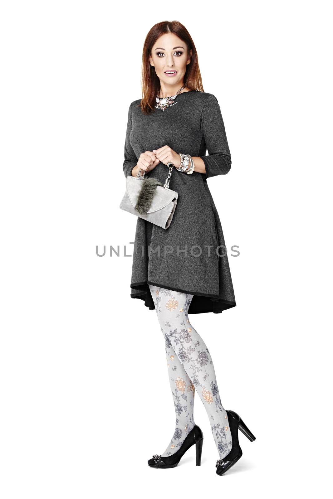 Full length studio portrait of woman with clutch bad isolated on white background.