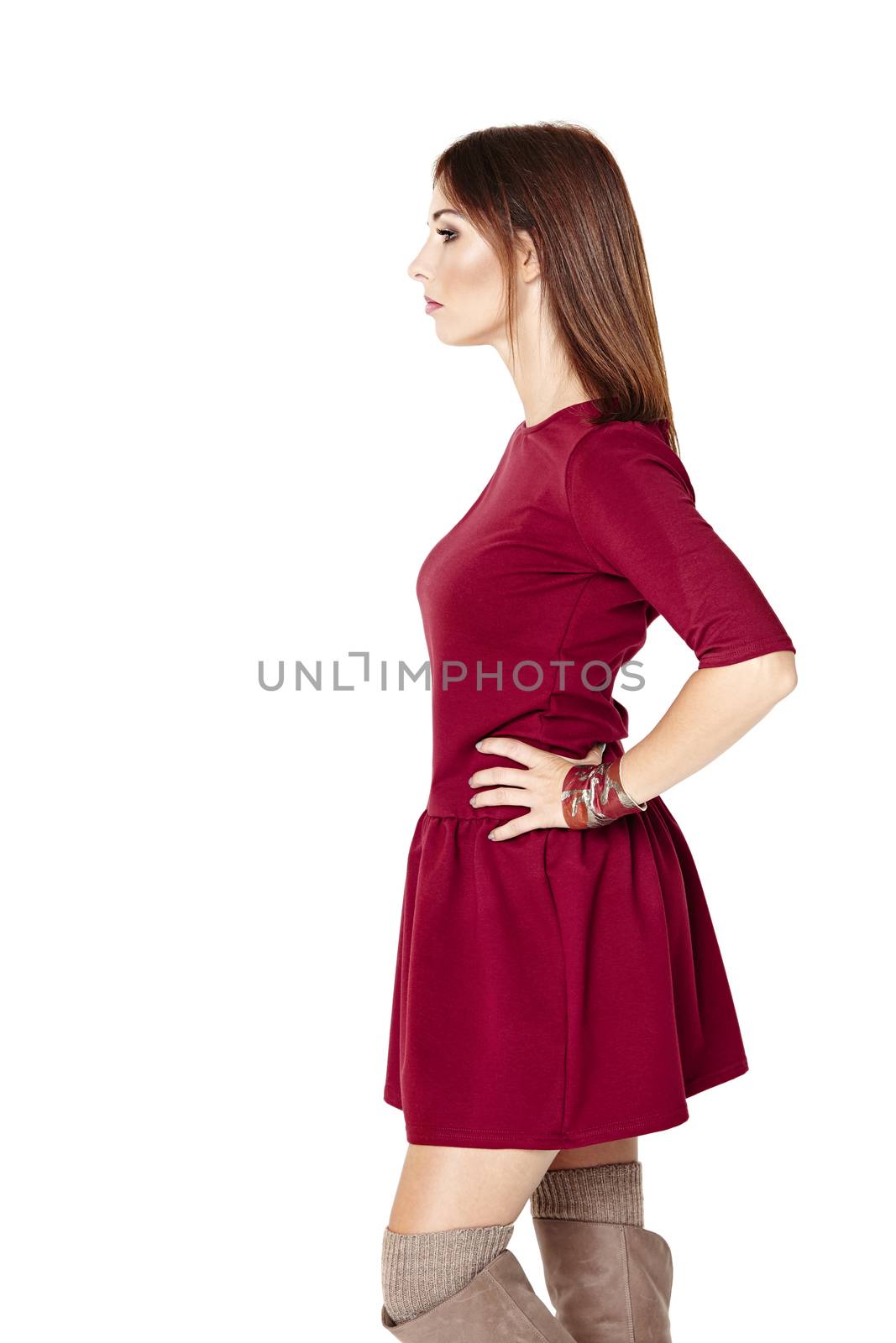 Side view of young woman posing in a red dress.