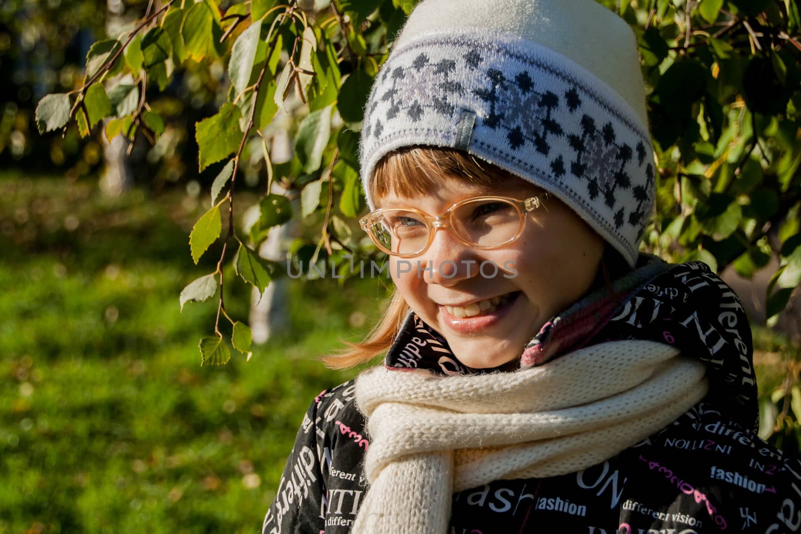 Young woman wearing glasses smiling in the fall