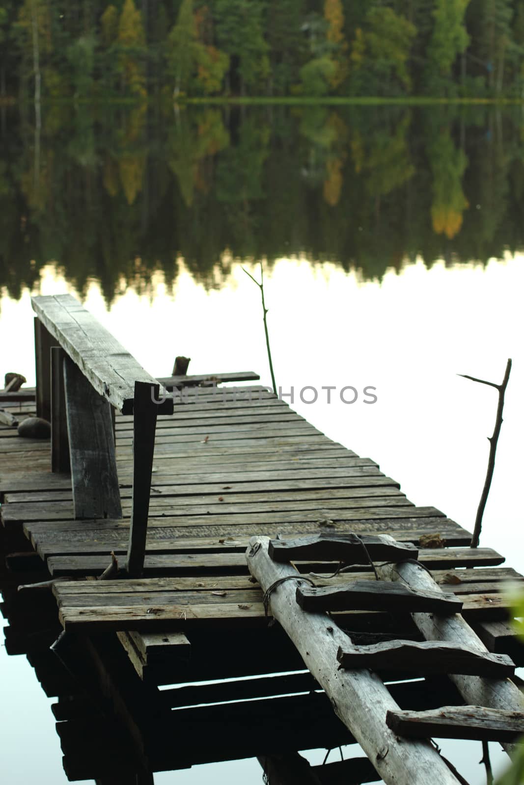 Old pier on a lake in the fall to catch fish