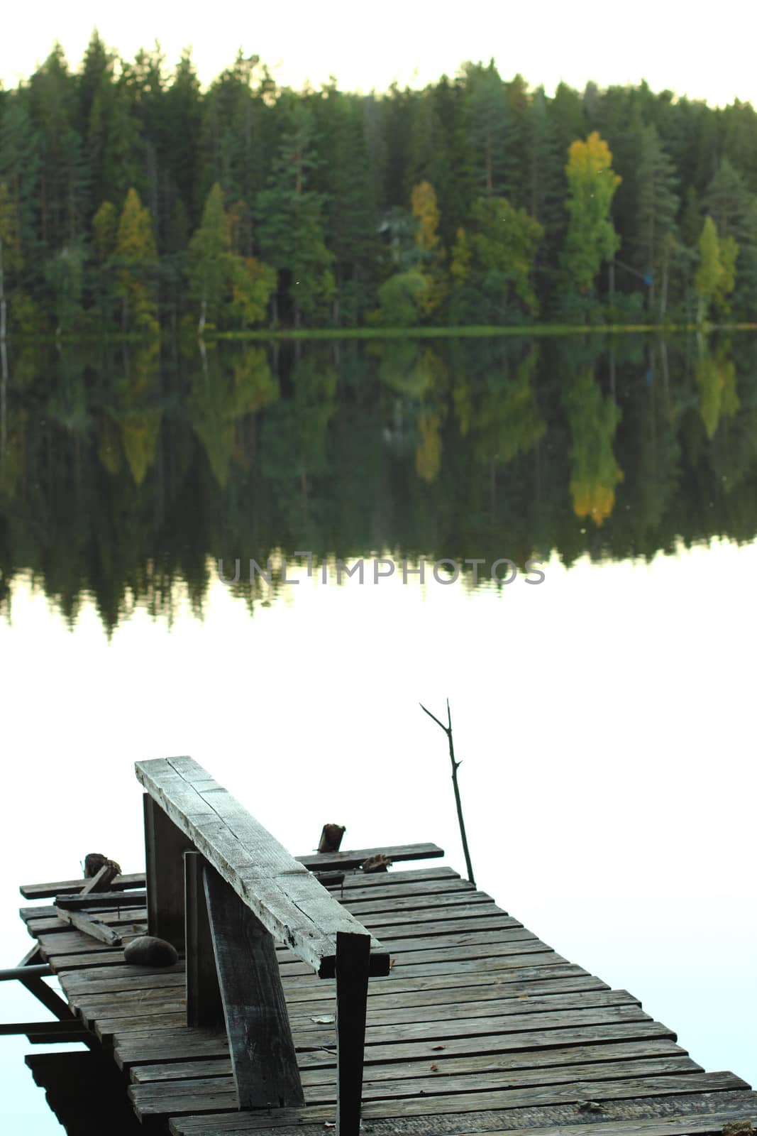 Old pier on a lake in the fall to catch fish
