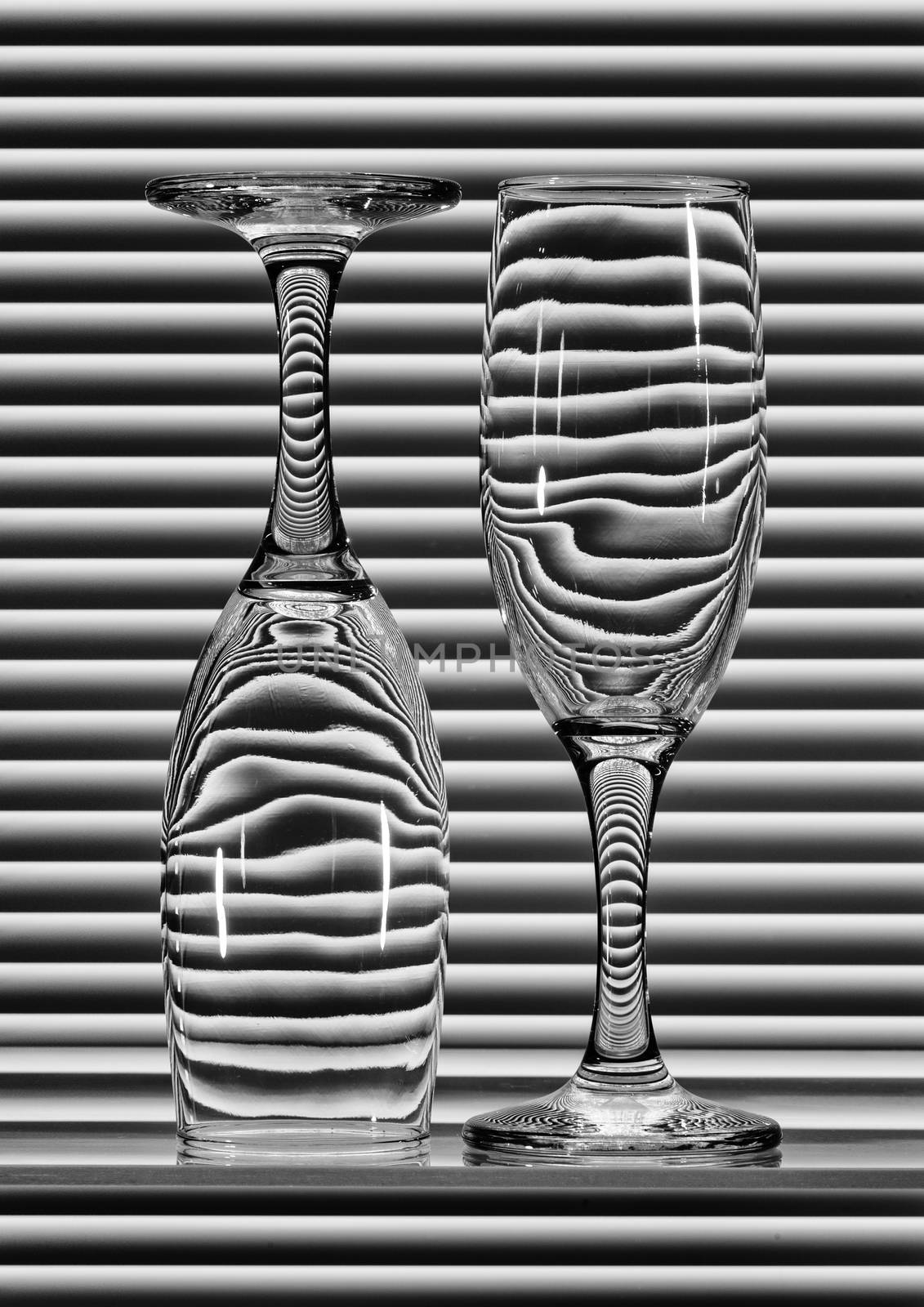 Two empty glasses with bands of reflection blinds