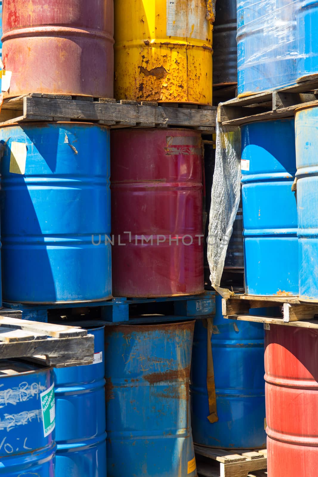 Rows of stacked steel barrels of various colors