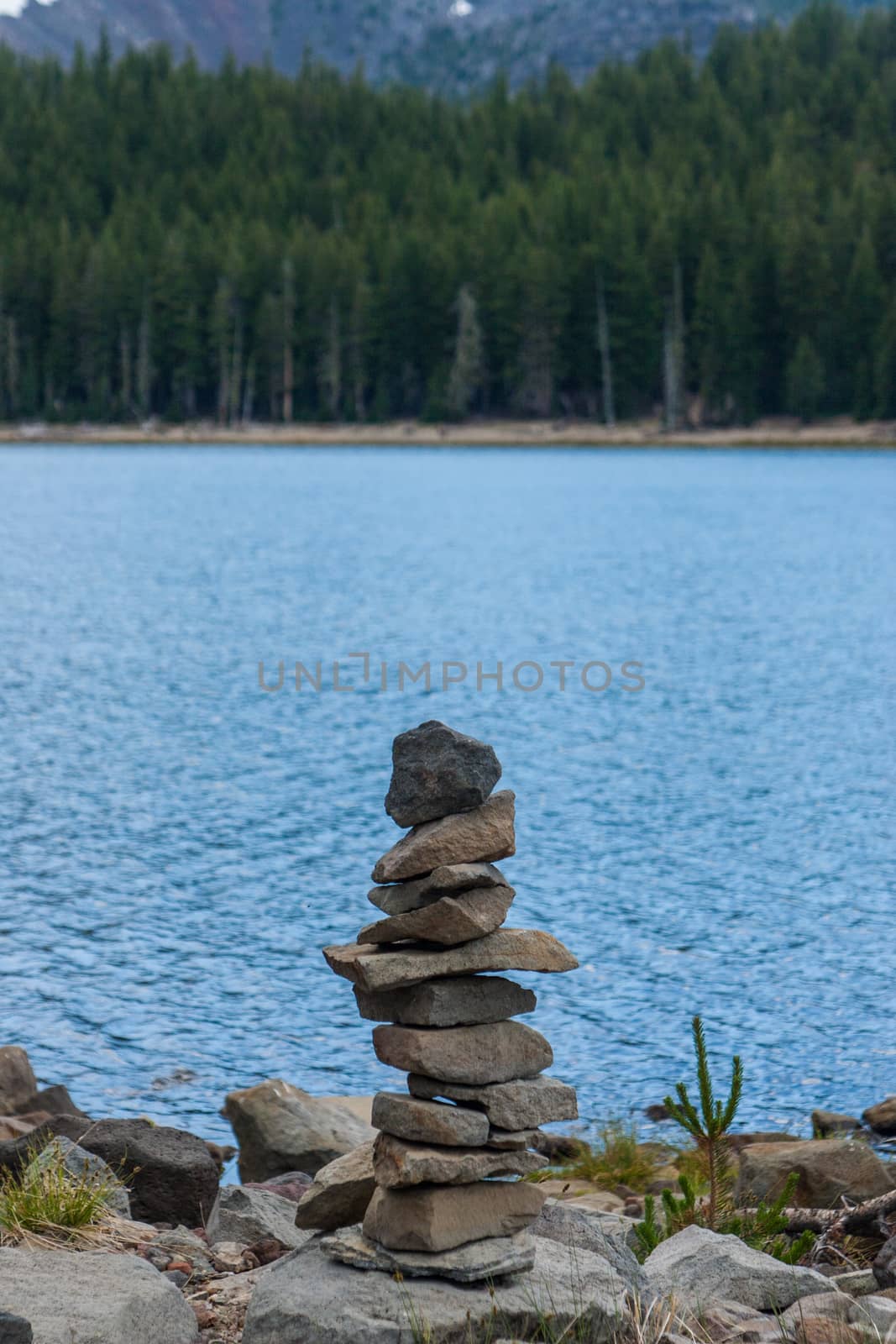 Small cairn on the shore of a lake by johnborda