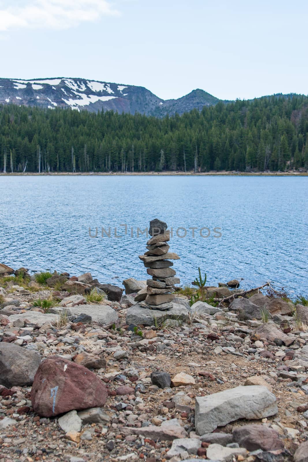 Small cairn on the shore of a lake