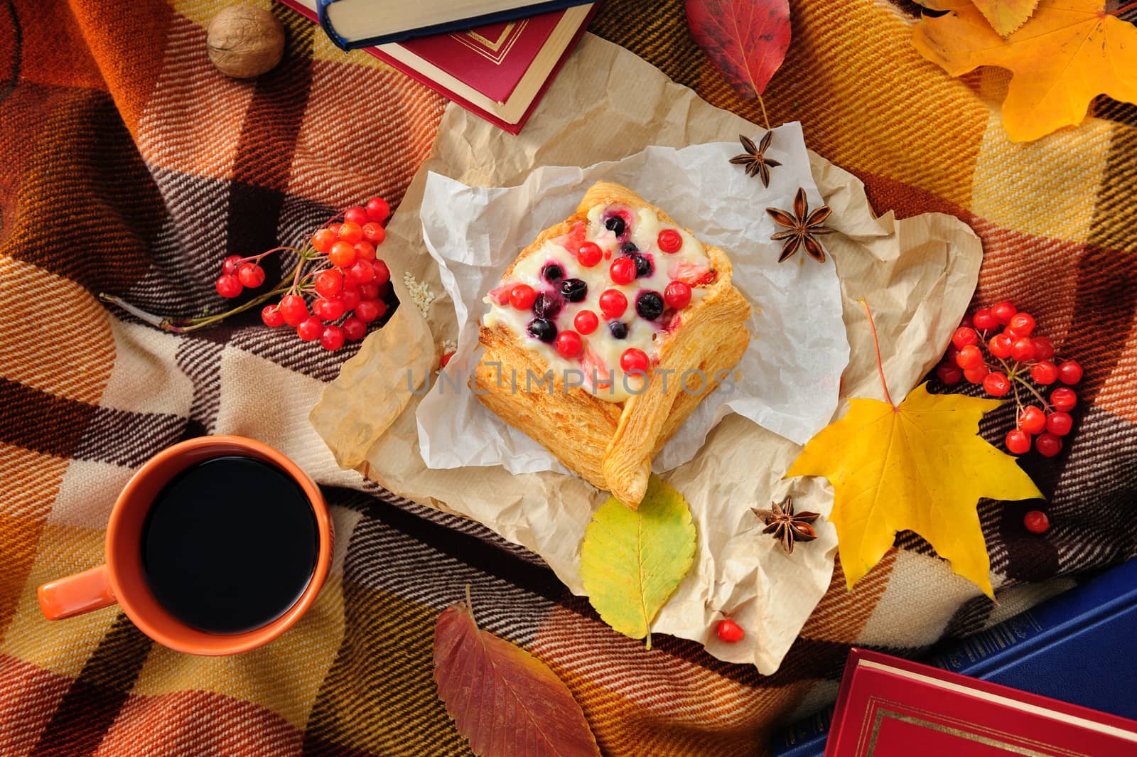 Romantic autumn still life with blanket, cake, book, coffee cups and leaves, top view