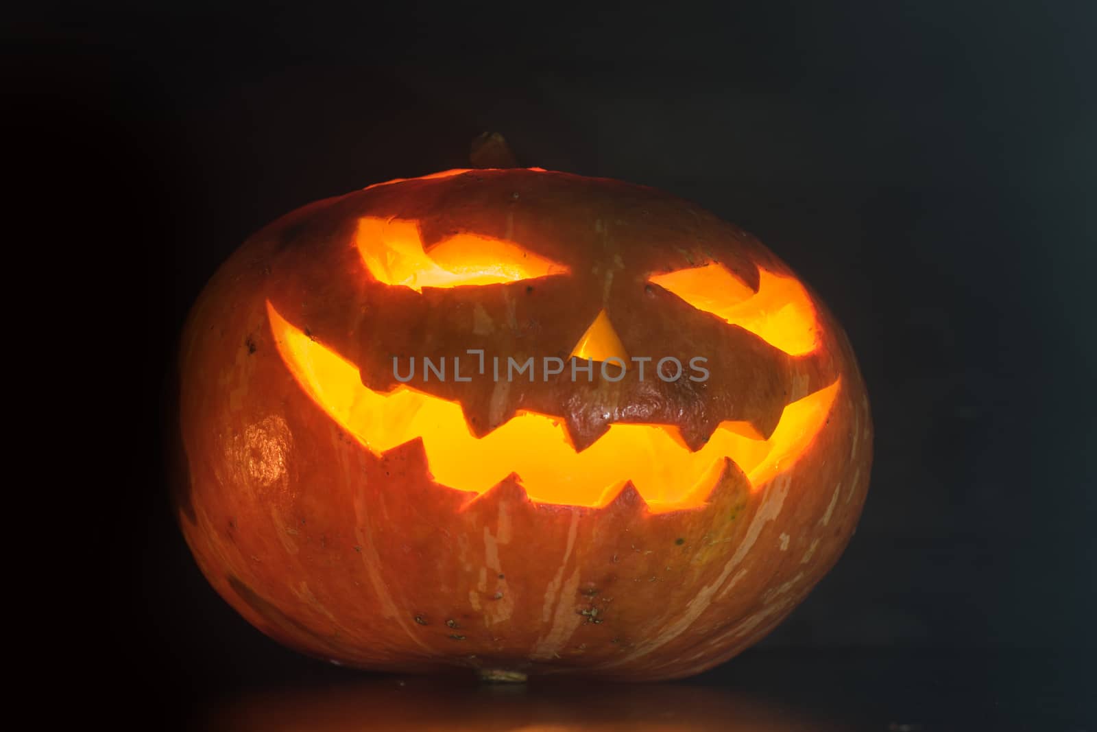 Halloween pumpkin with scary face on black backgound