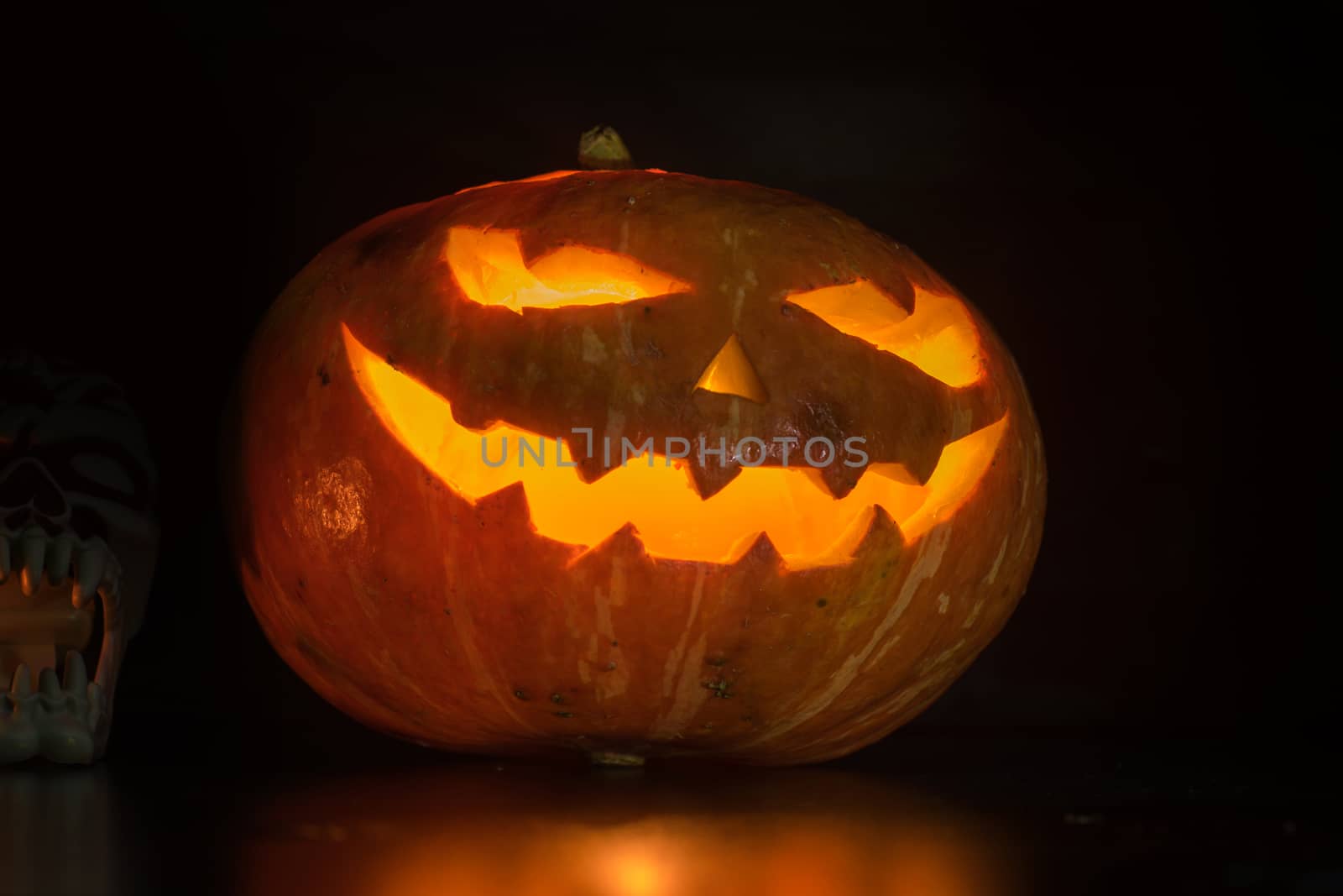 Halloween pumpkin with scary face on black backgound