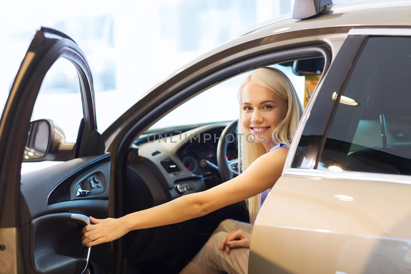 auto business, car sale, consumerism , transportation and people concept - happy woman sitting in or driving car