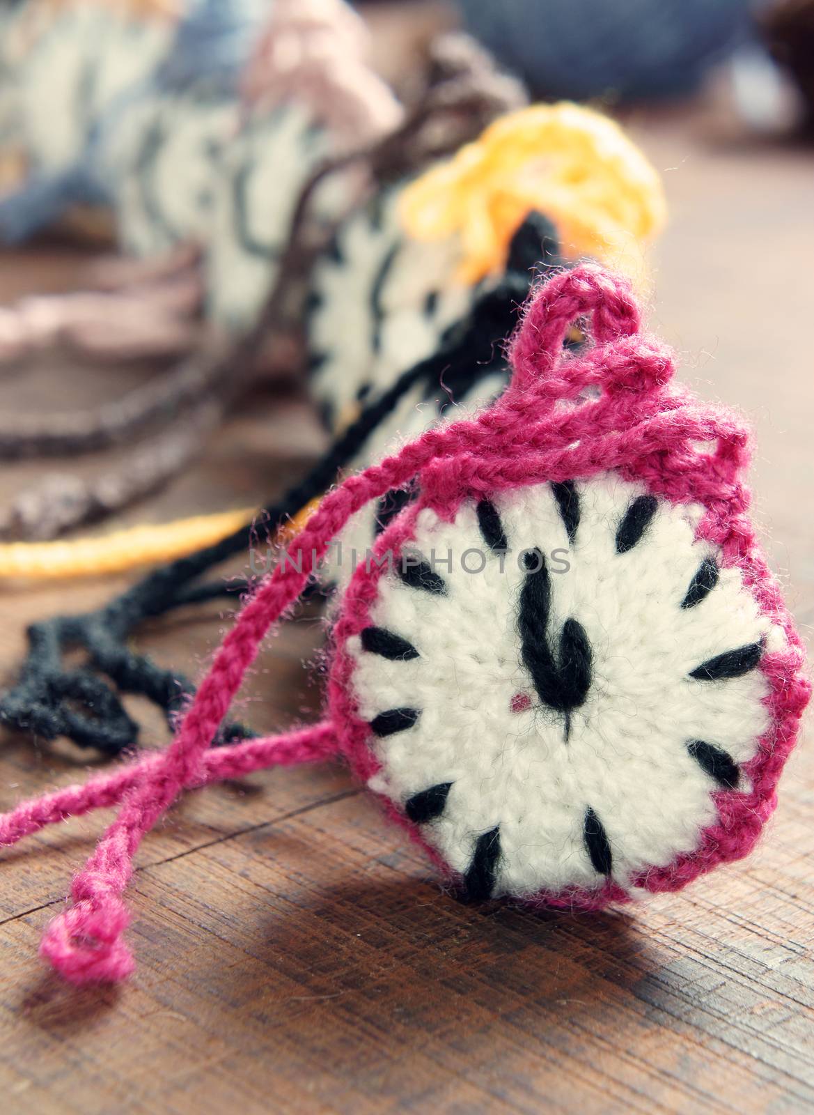 Amazing knitted clock, group of colorful watch make from yarn to happy new year, wonderful idea for handmade hobby, in warm color, abstract art