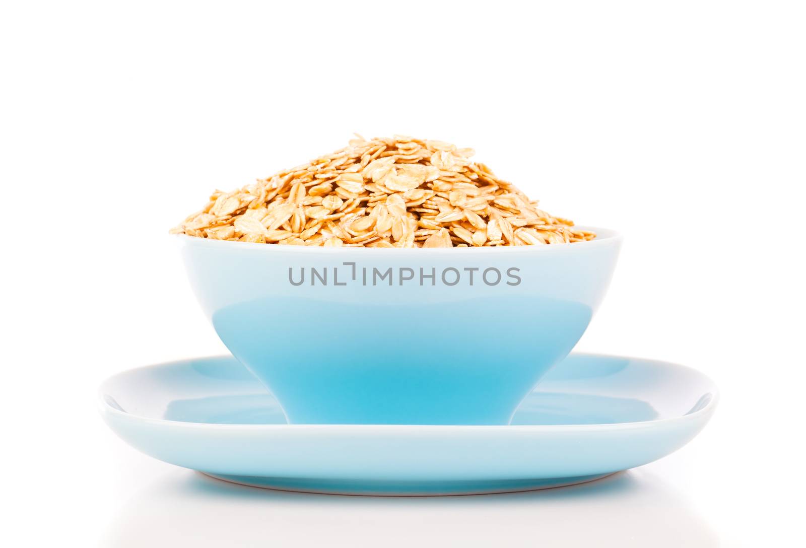 Cornflakes in porcelain bowl isolated on white background by motorolka