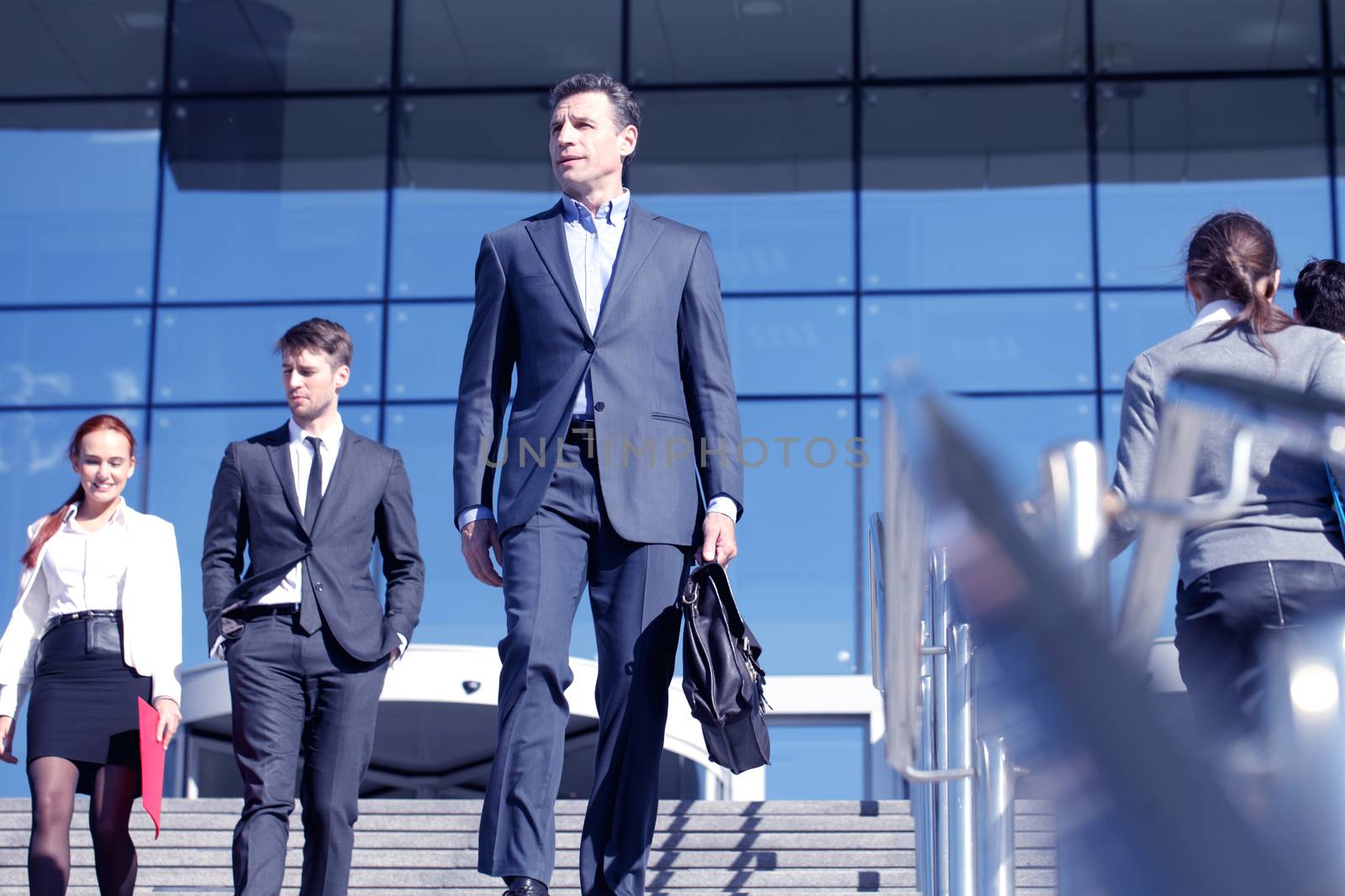 Team of diverse business people at stairs of company office building