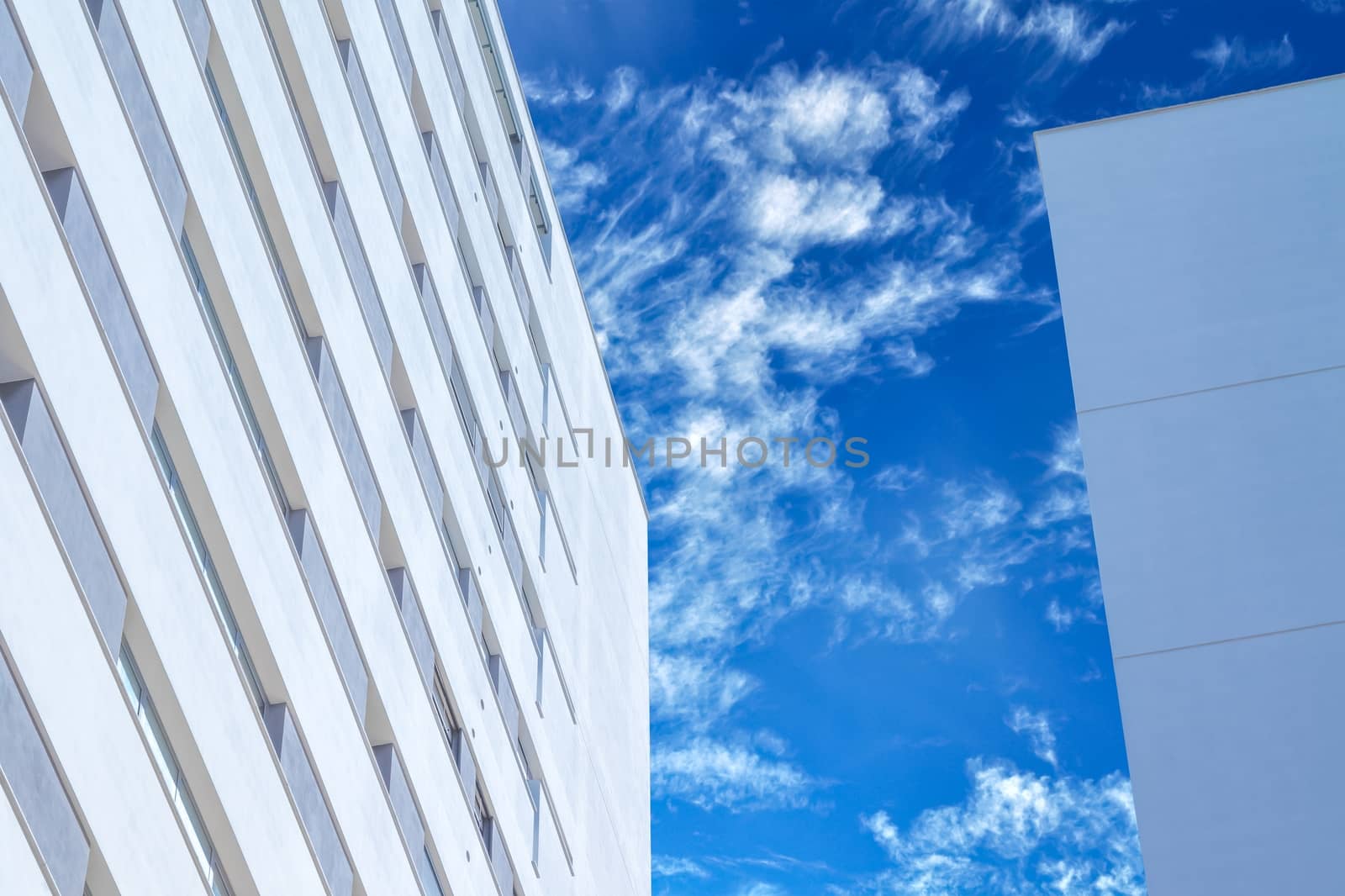 skyscrapers under blue sky with white clouds