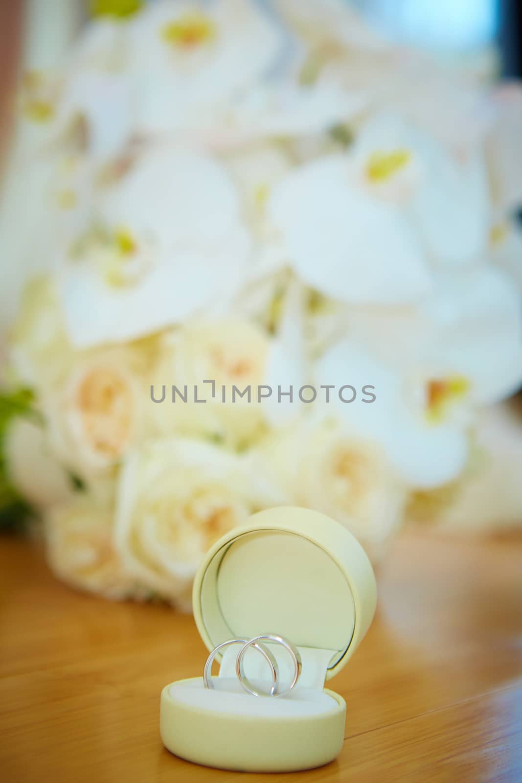 The wedding bouquet and silver rings. Shallow DOF