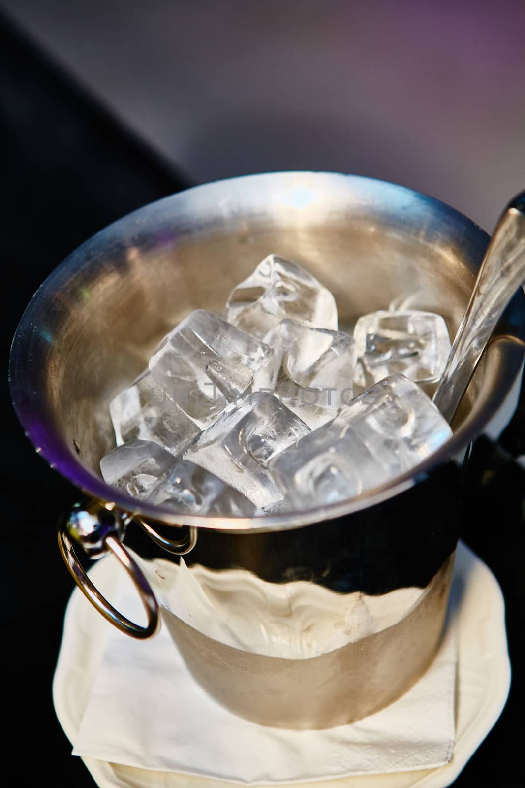 Close up ice in metal bucket in the restaurant