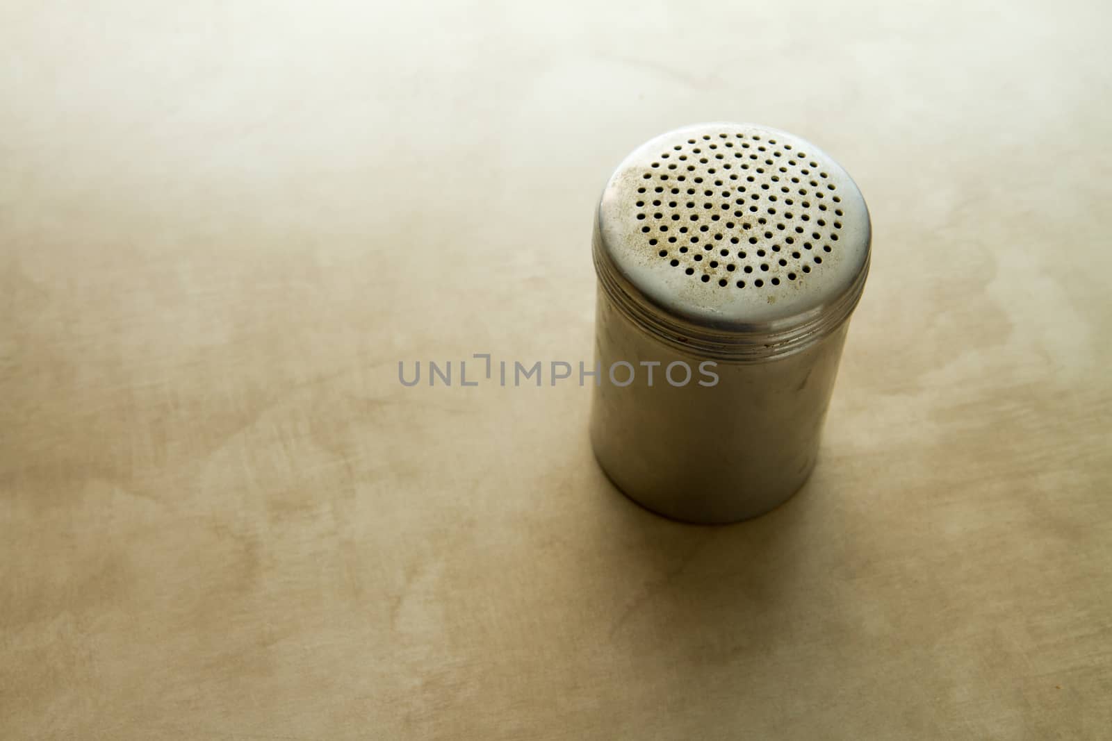 Used salt shaker sitting on the kitchen counter during cooking