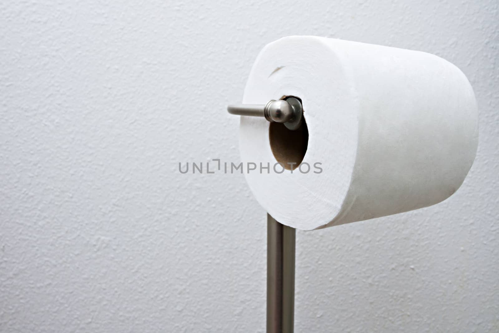 Lone roll of toilet paper waiting for someone to use