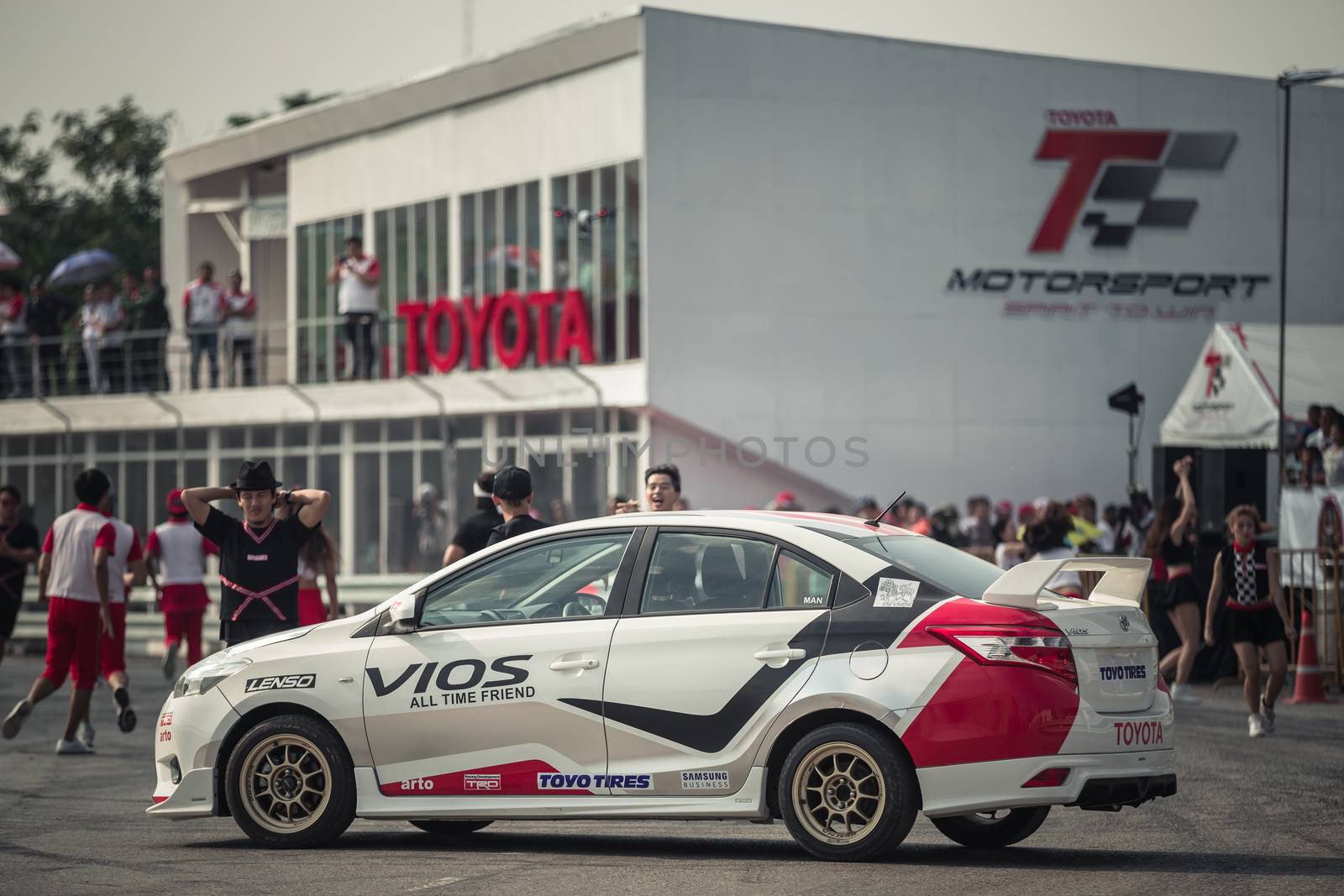 Udon Thani, Thailand - October 18, 2015: Toyota Colora Altis performance show on the track at the event Toyota Motor Sport show at Udon Thani, Thailand. This show is that the car carry a cheer leader for the dance show at the breaking time.